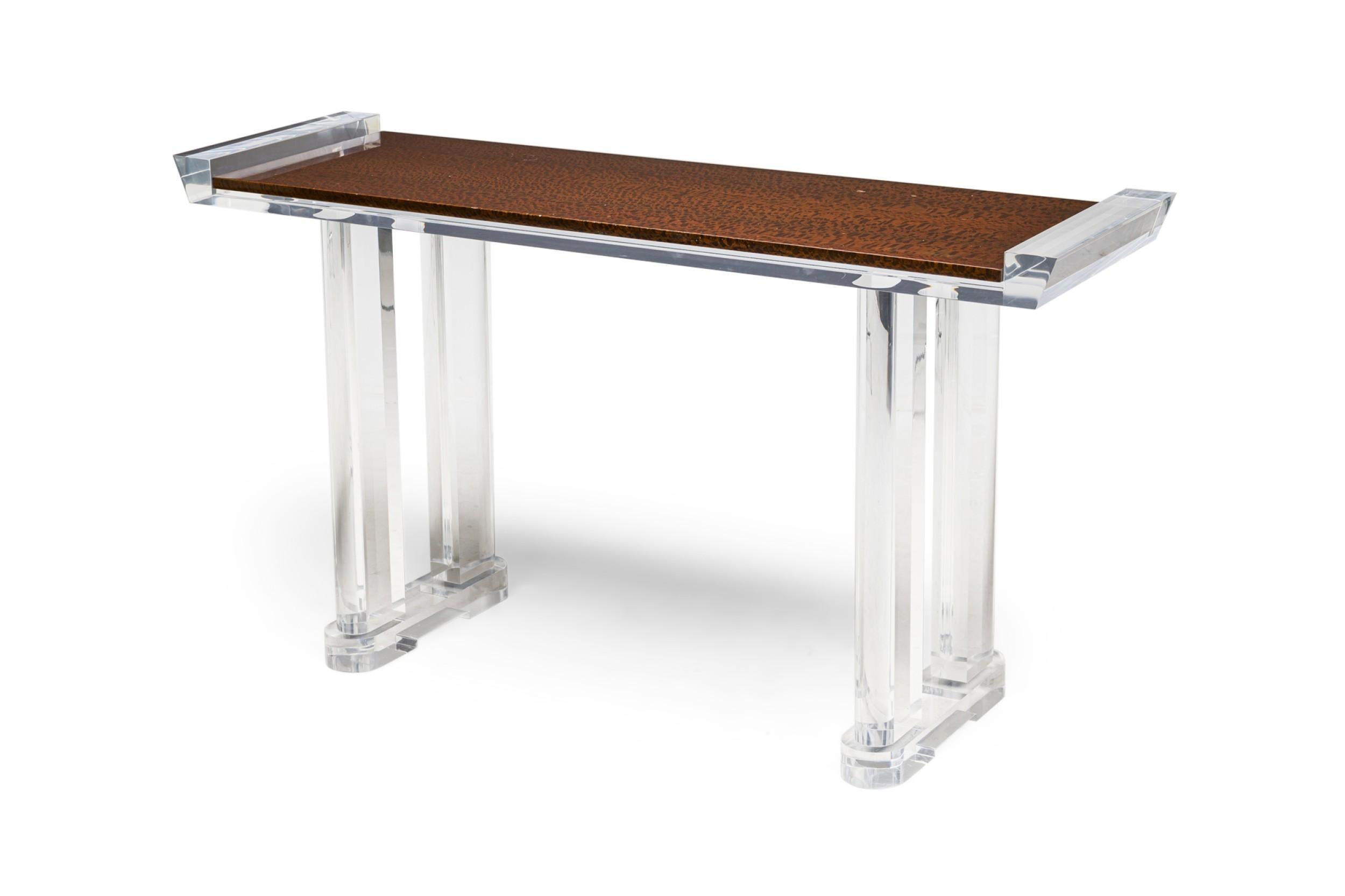 American Contemporary Lucite console table having double rectangular column sides resting on oval bases supporting a top with raises sides.between a glass top surface