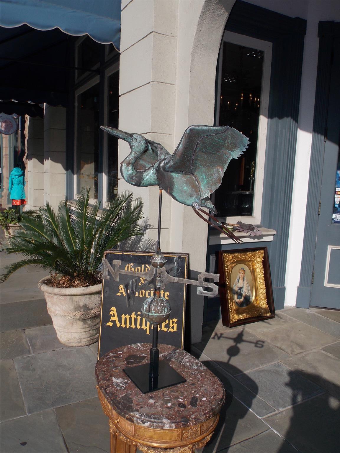 American copper egret weathervane with a zinc directional, double copper sphere's, and mounted on squared iron stand. Late 19th century