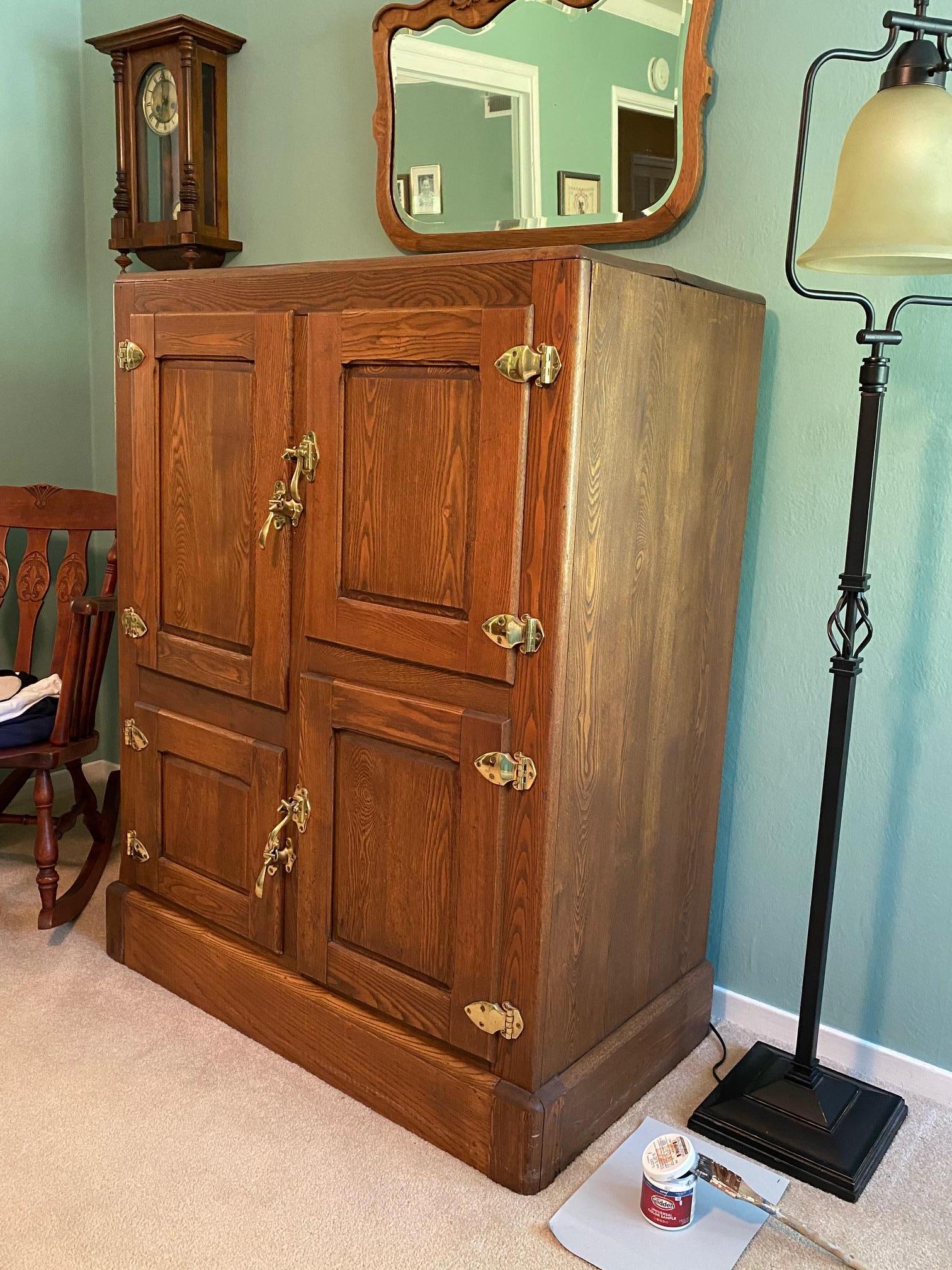 An authentic beautifully restored turn of the century DeWitt Switzerland Co. ice box having brass hardware and porcelain & zinc interior.