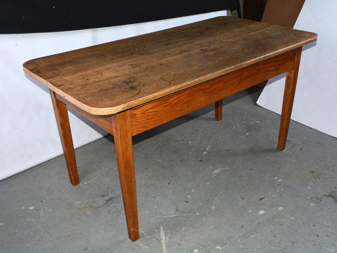 The American country dining table is simplicity itself. The wood plank top with rounded corners and wonderful aged patina is secured to the apron of the base by wood strips on all four sides. Picture this in a country kitchen or dining room. Seats