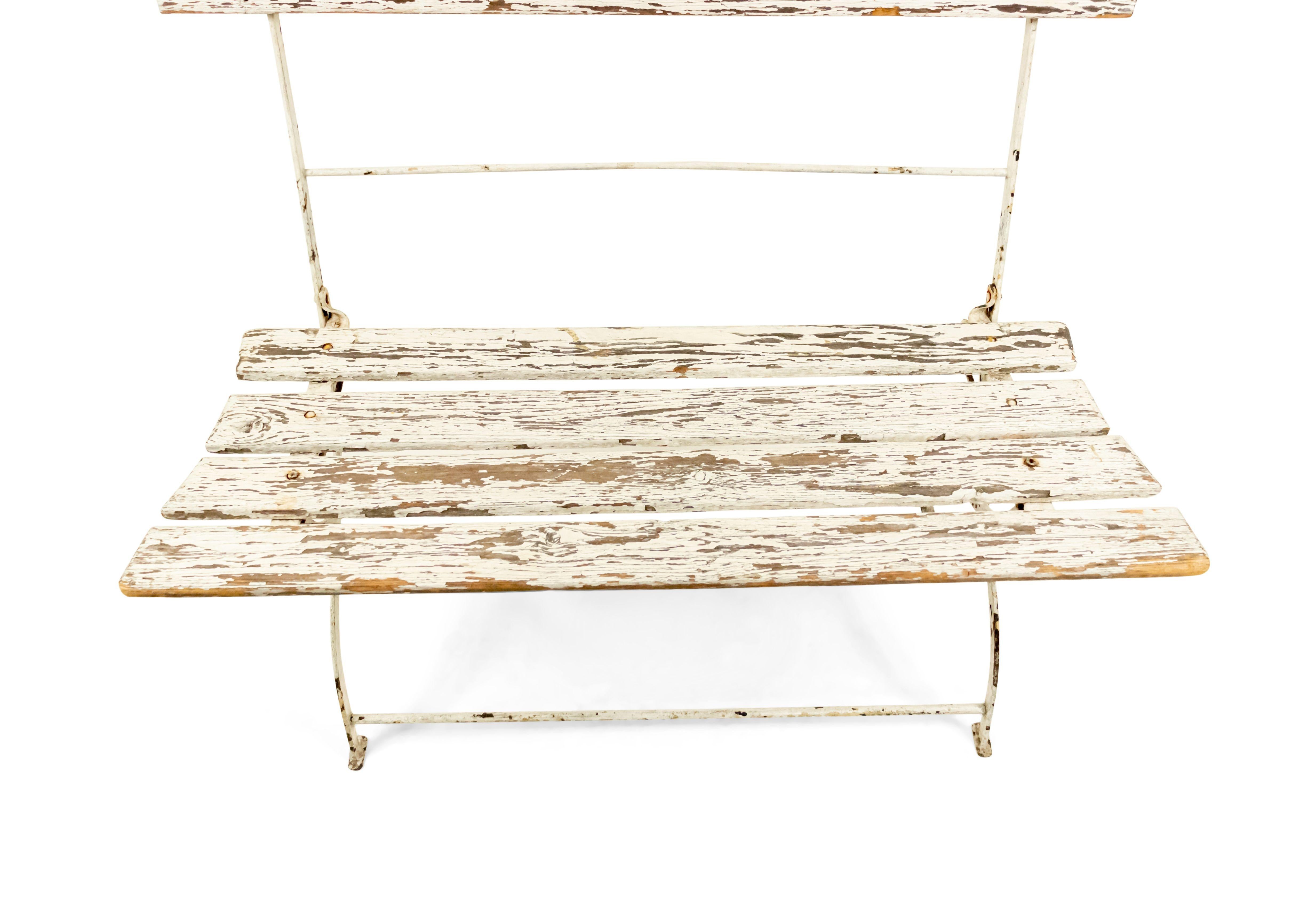 American Country style Outdoor folding iron loveseat with a weathered white painted wood slat design seat and single slat back.
     
