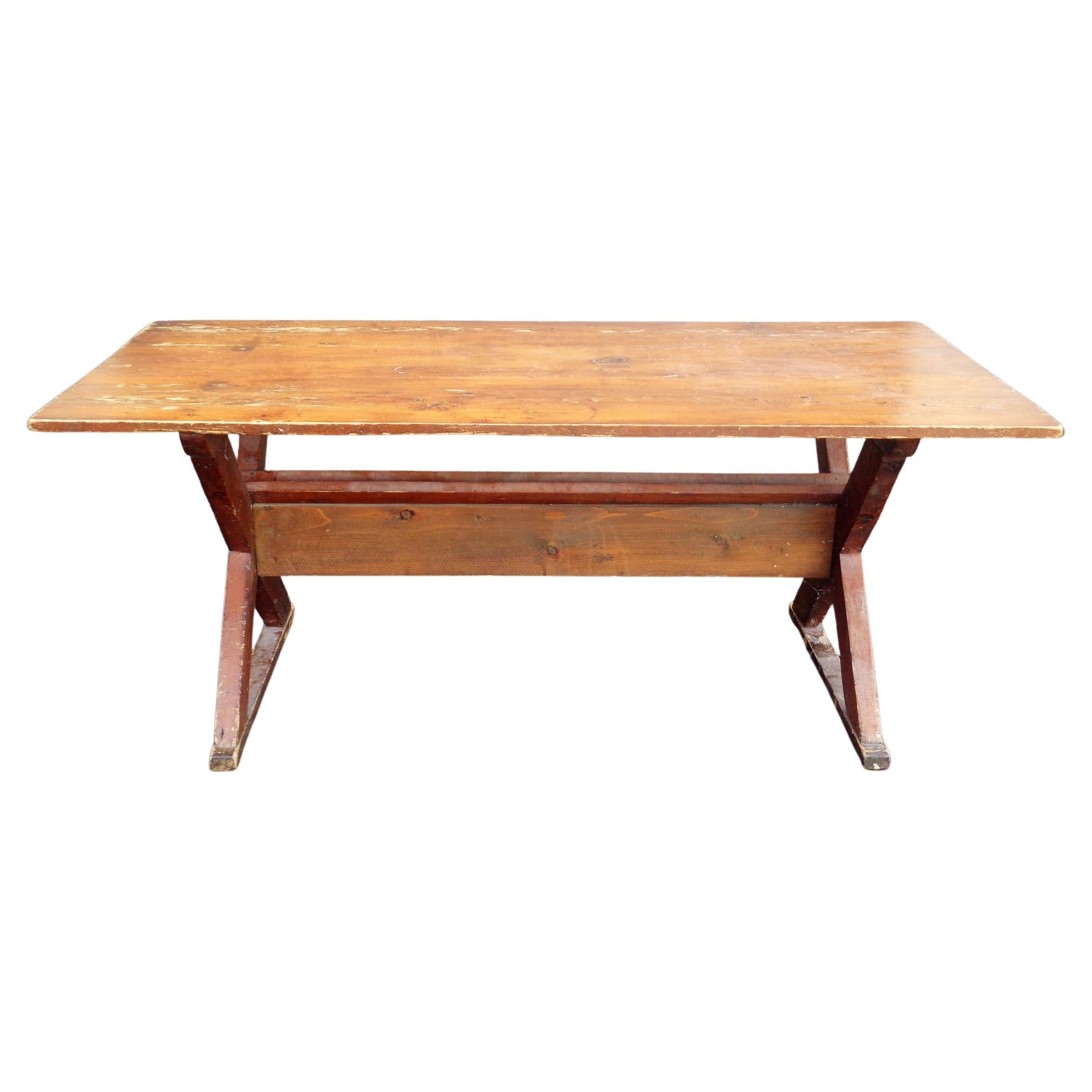 American country pine sawbuck trestle table with one inch thick wide three board top in overall nicely aged original old surface color patina. Circa 1940. Measures 68 1/2