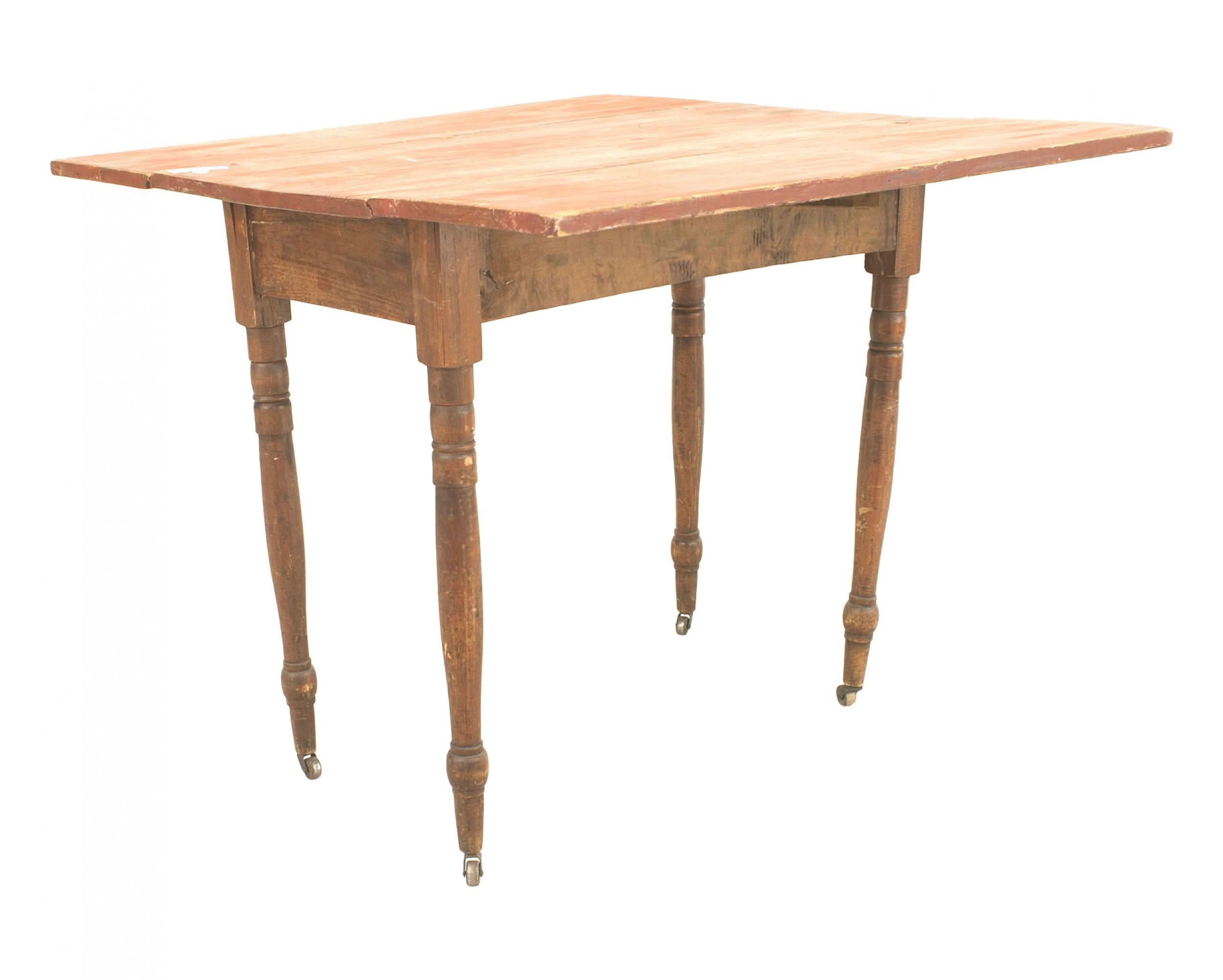 American Country Rustic-Style (19th Century) rectangular antique red painted pine drop leaf dining table with round legs.