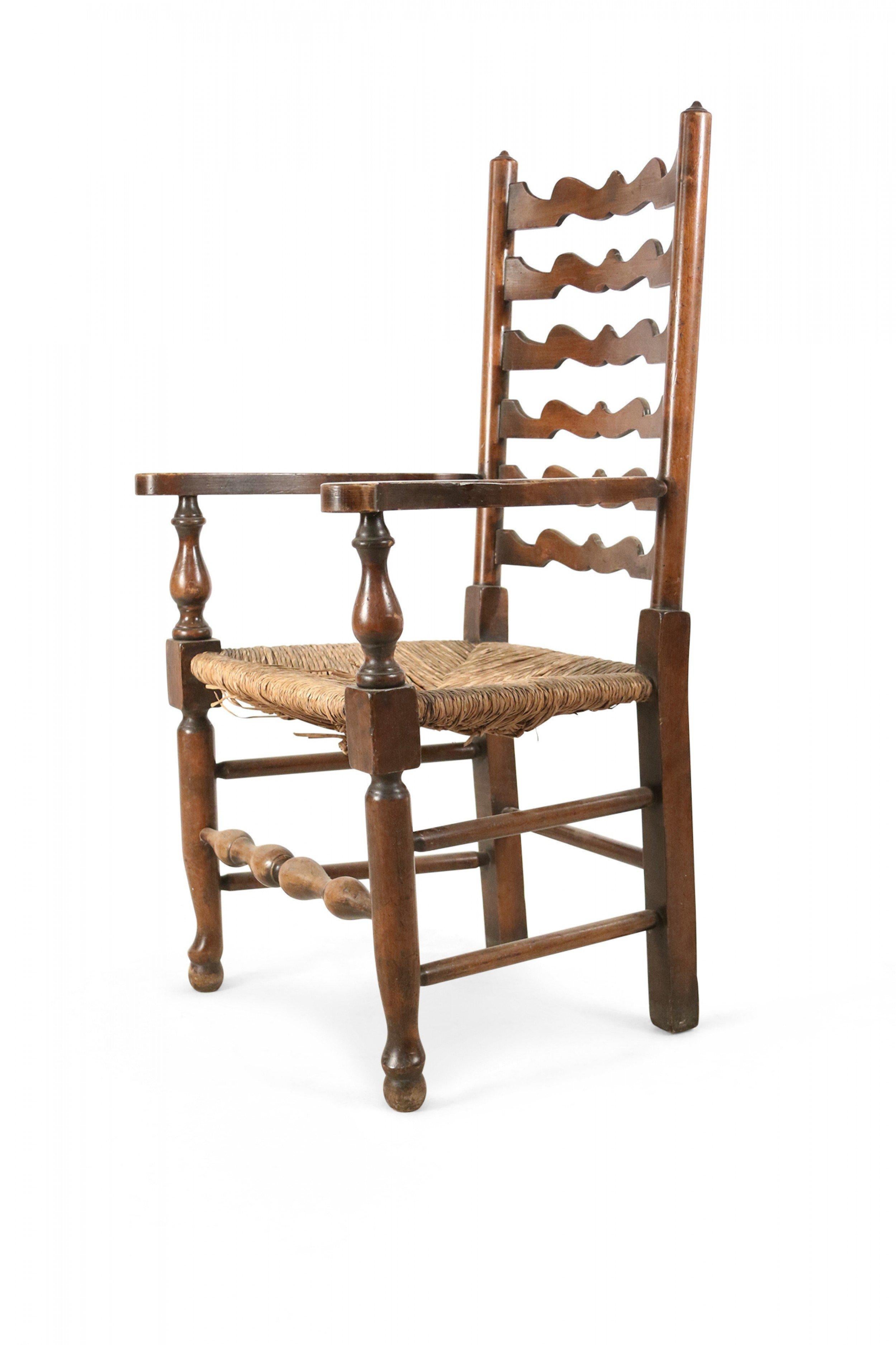 American Country Rustic-style wooden scalloped ladder back arm chair with a woven rush seat and box form stretcher.