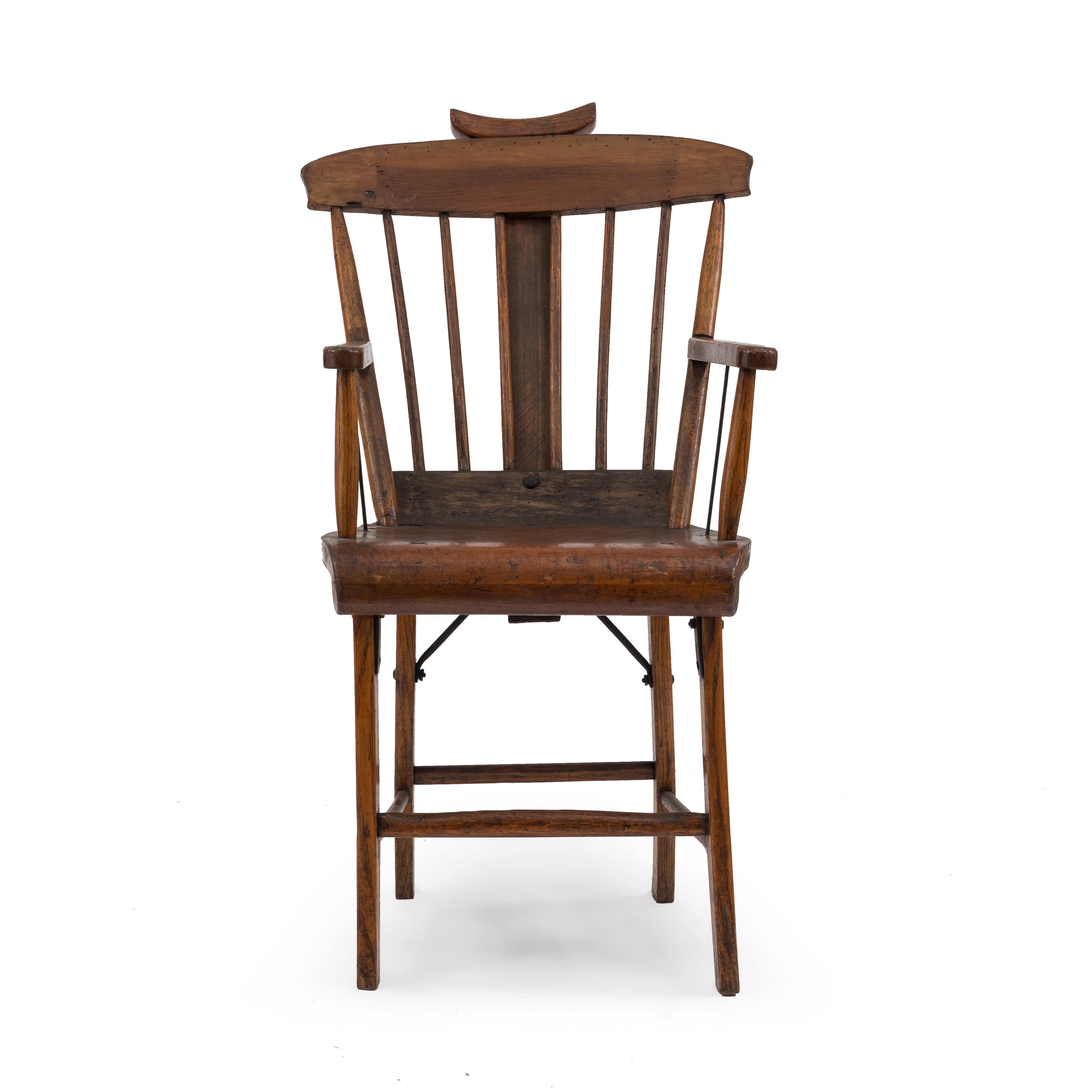 American Country (19th century) stained pine armchair with spindle back and adjustable headrest.
