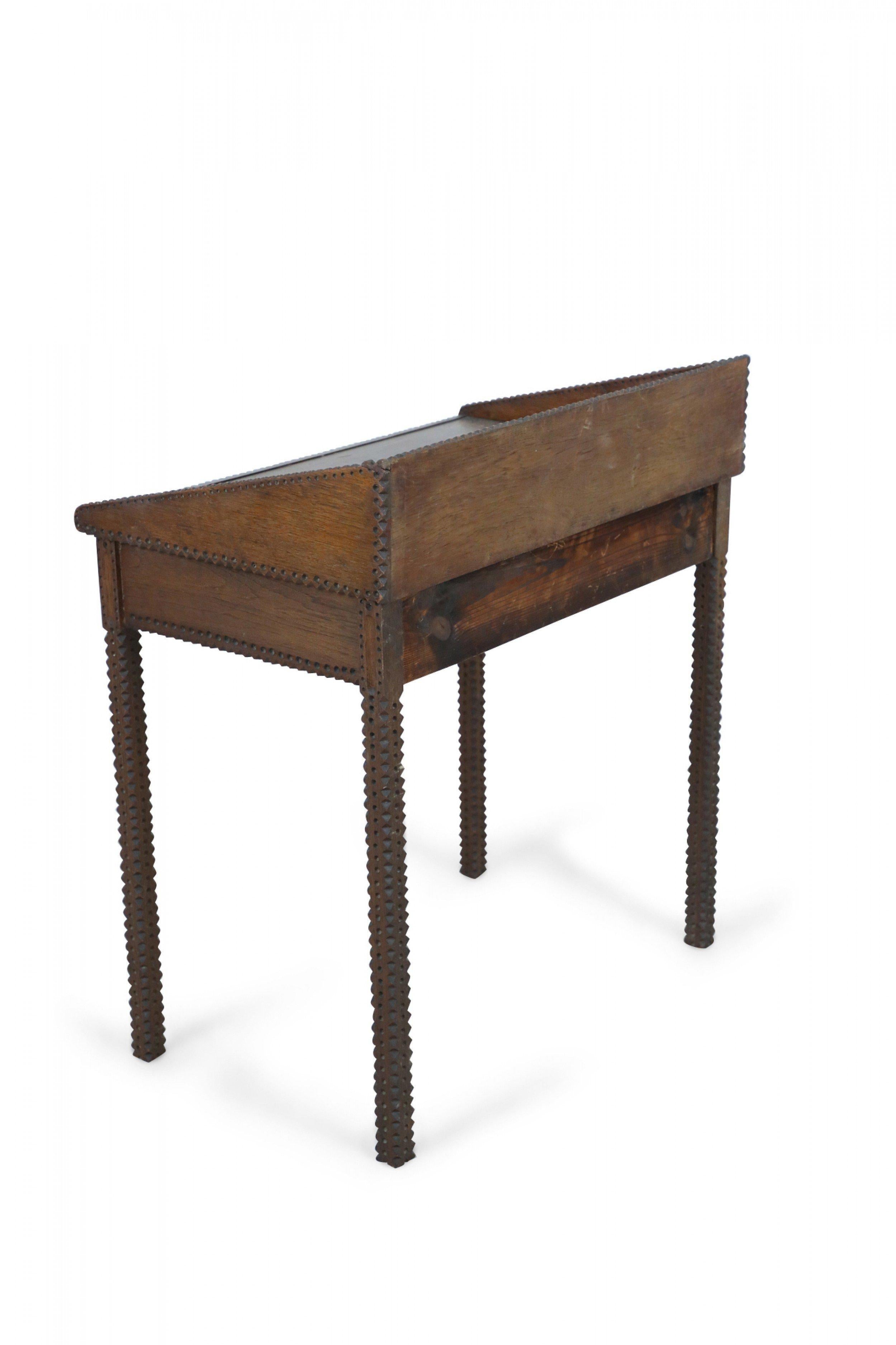 American Country Tramp Art-style secretary desk with two drawers, a low back and side gallery, and notch-carved edges and legs.
 