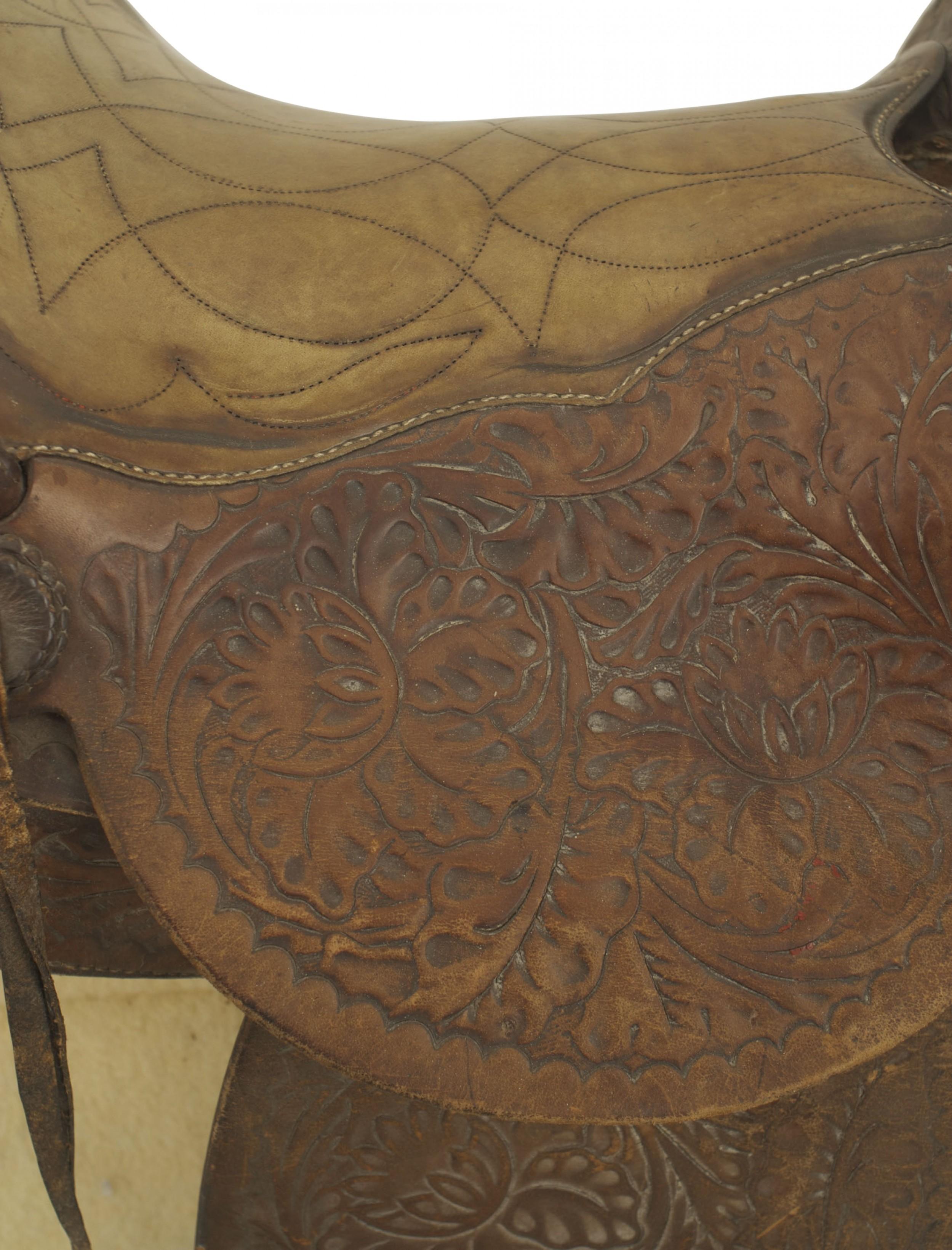 American Country Western-style brown leather horse saddle with embossed and tooled design and a sheepskin blanket.