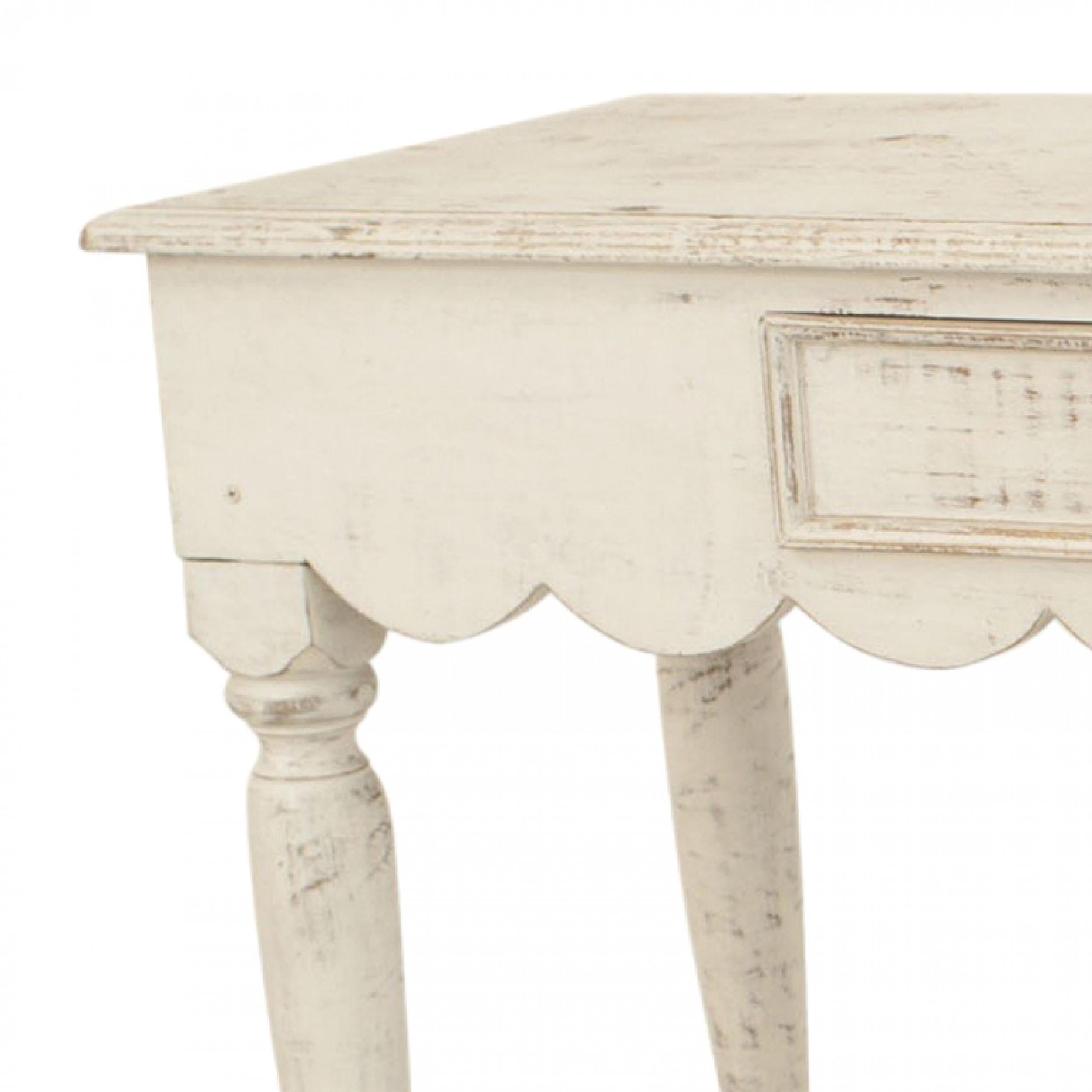 American Country (19th Century) console table with an antique white painted finish and a scalloped design apron with a single front drawer supported on turned legs.