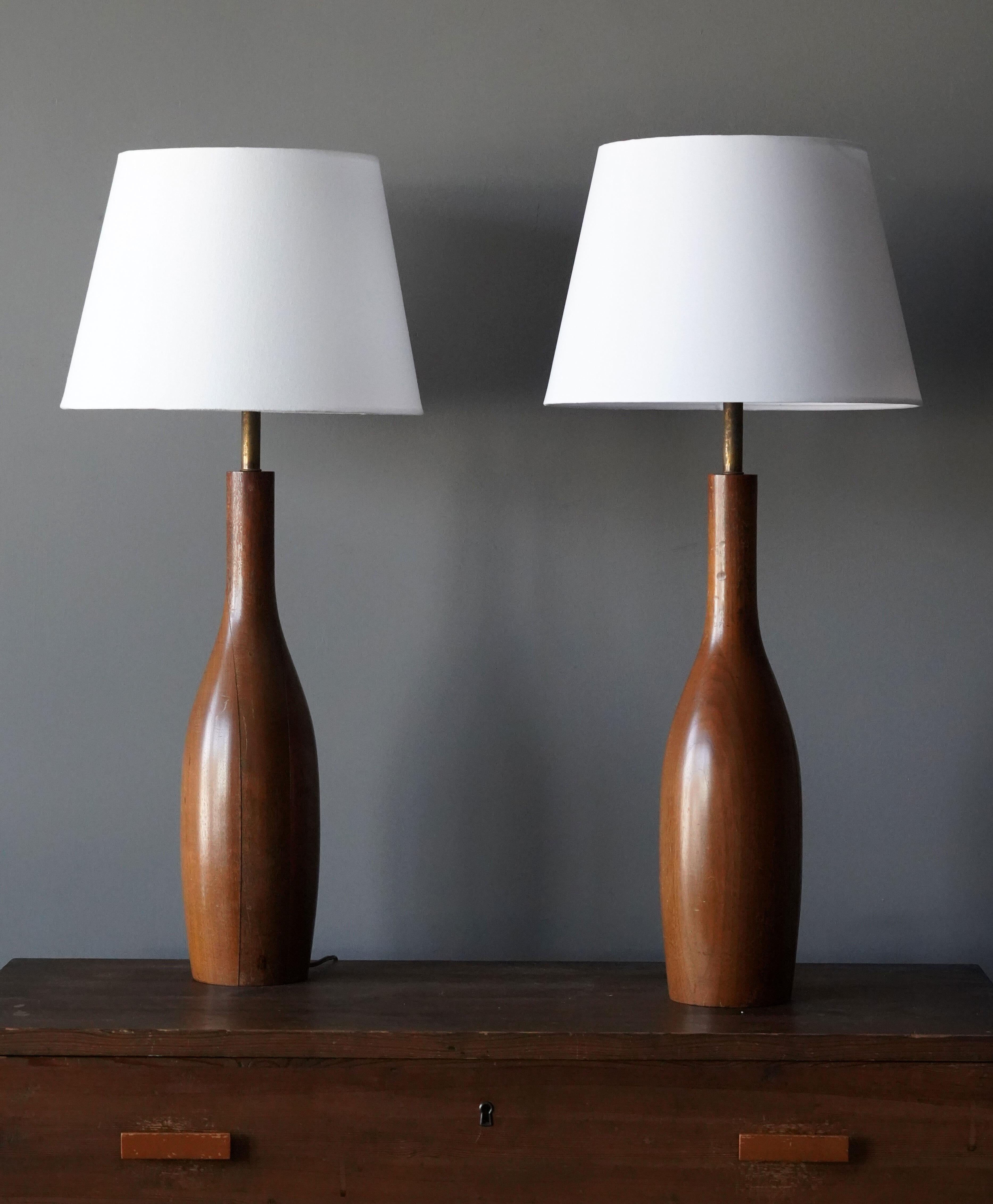 A pair of large and organic table lamps. Features a finely turned walnut base, brass rods.

Sold without lampshades. Stated dimensions excluding bulbs and lampshade.

Glaze features a brown color.

Other designers of the period include Alexandre