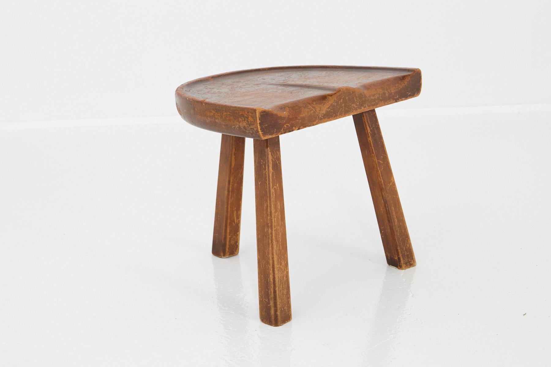 American craft movement three splayed leg milking stool with shaped seat in the style of Arthur Cunningham, circa 1950s. Great patina, very sturdy.