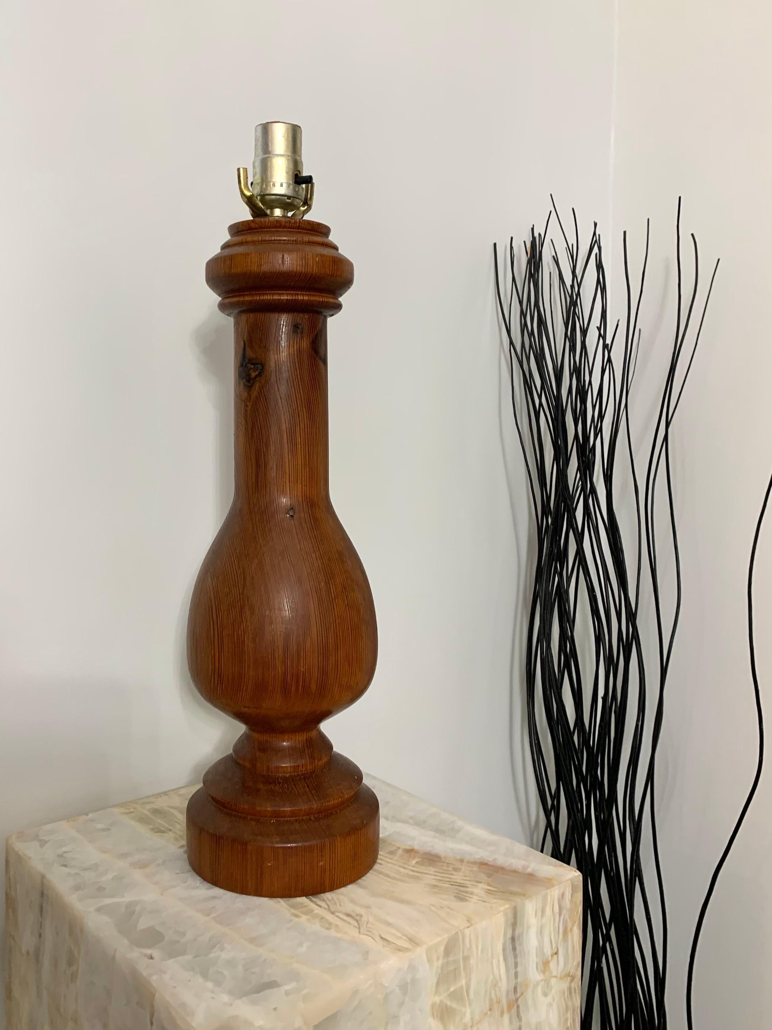 A table lamp. In finely turned reclaimed oak in a classic form. Designed and produced by an unknown studio craftsman who signed THP. Made in 1977. Beautiful patina to the wood and brass. 

Has remnants of its past life with old nail holes and one