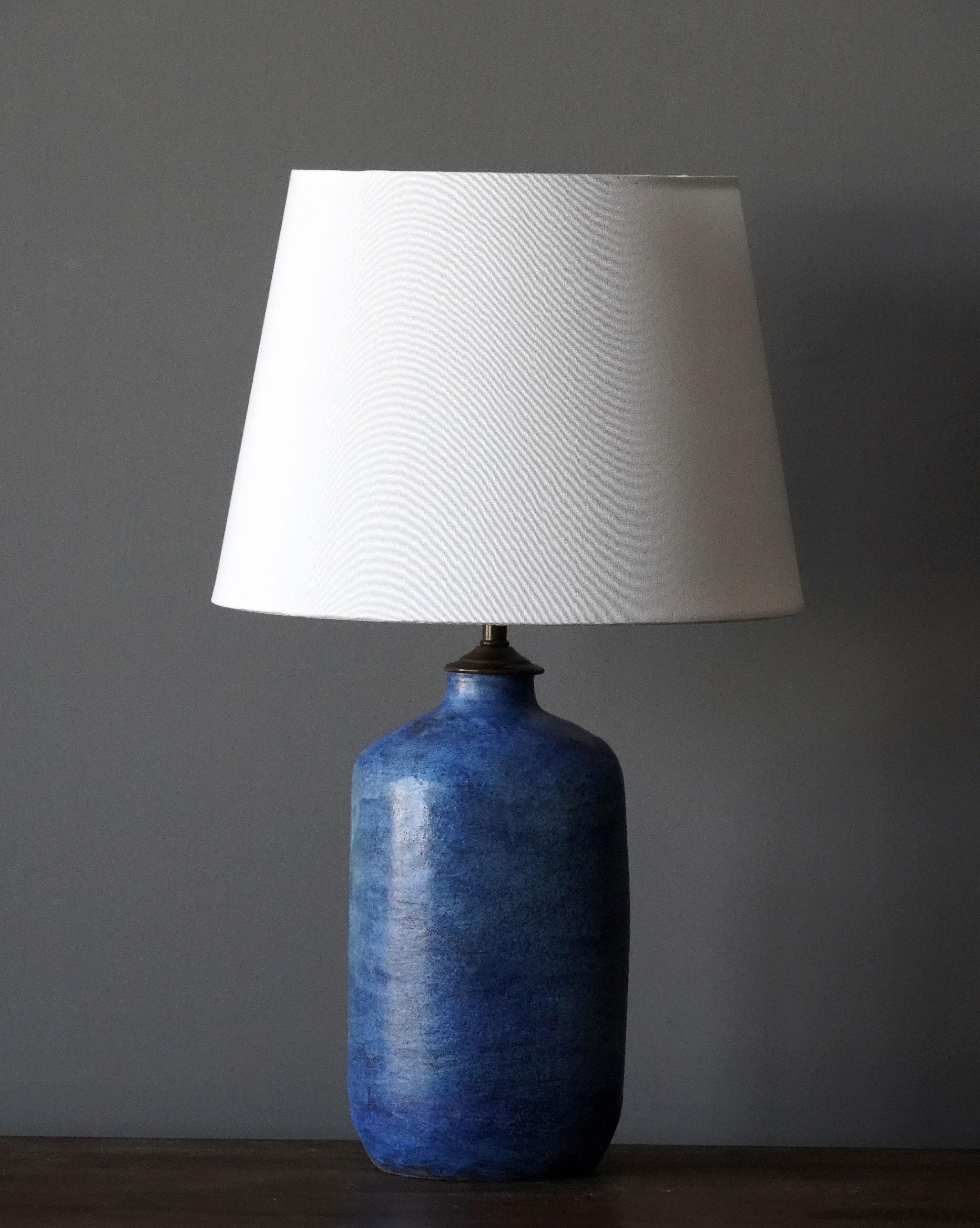 A table lamp. Features blue painted stoneware base. Brass rod.

Sold without lampshade. Stated dimensions excluding bulbs and lampshade.

Other designers of the period include Alexandre Knoll, George Nakashima, Isamu Noguchi, J.B. Blunk and Paul