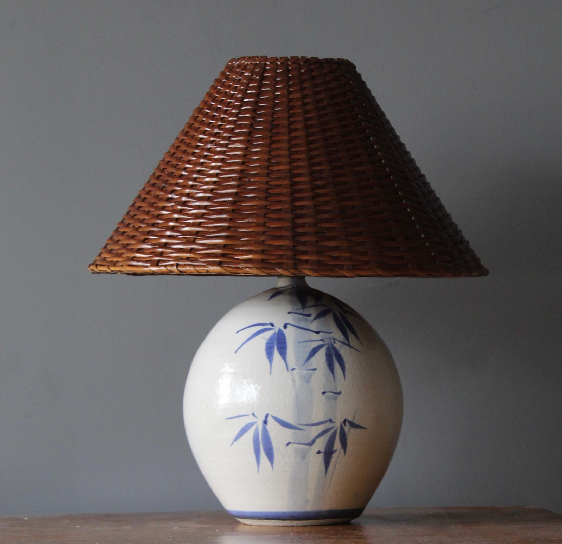 A table lamp. In ceramic, brass. By unknown studio craftsman. With assorted rattan lampshade.

Stated dimensions include lampshade.

Other designers of the period include Alexandre Knoll, George Nakashima, Isamu Noguchi, J.B. Blunk and Paul
