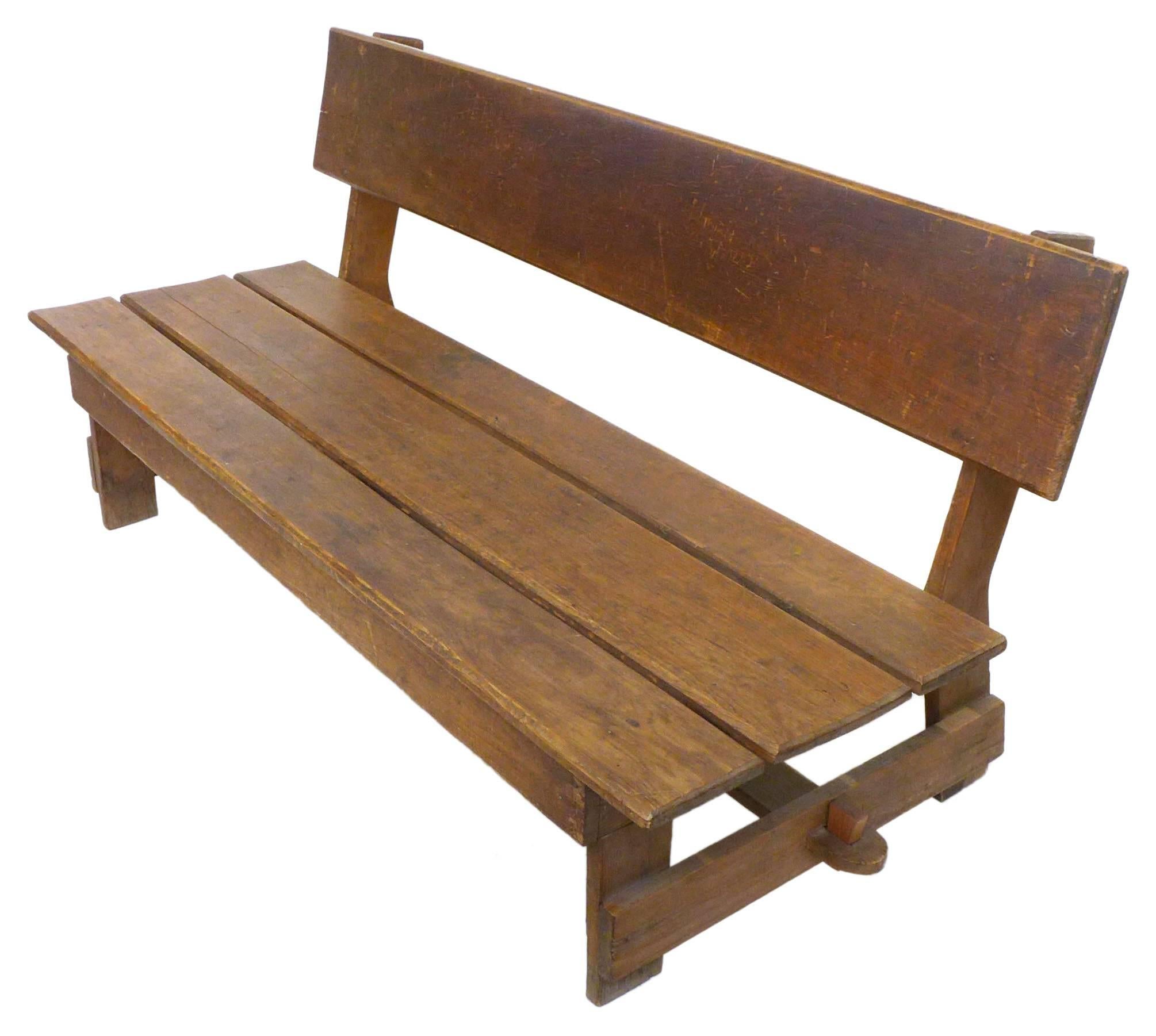An exceptional American craft wood slat bench. An elegant, perfectly simple, utilitarian construction primarily of plain, cut boards with decorative, through-mortise-and-tenon joint at the cross-stretcher. Great from all angles with wonderful scale