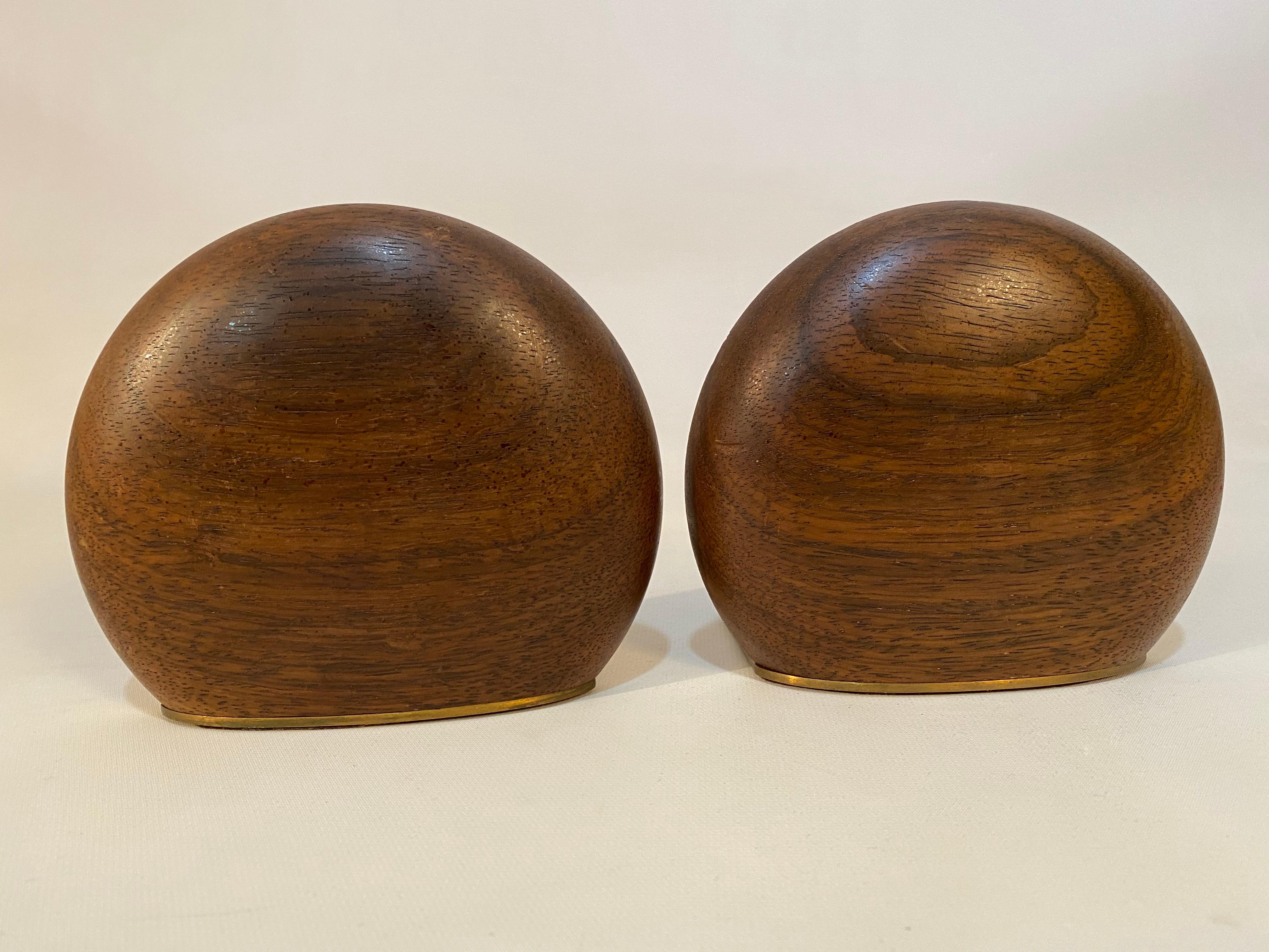 A fine pair of American Crafts movement Wenge and bronze bookends. Convex carved solid wood with bronze stands, circa 1960-1965. Good condition with roughness and splintering to one edge (see photos). Oiled, low luster finish.

Approximately