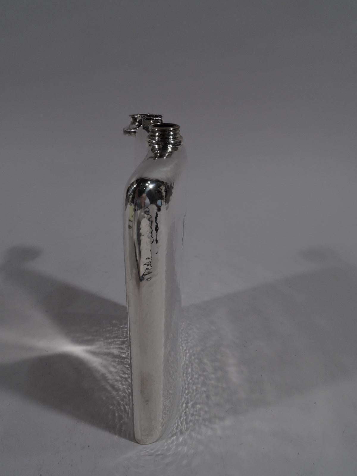 American Craftsman sterling silver flask. Made by Webster in North Attleboro, Mass., circa 1920. Curved rectilinear body with threaded and cork-lined cover. all-over hand hammering. Plain and engraved rectangular frame (vacant). Fully marked