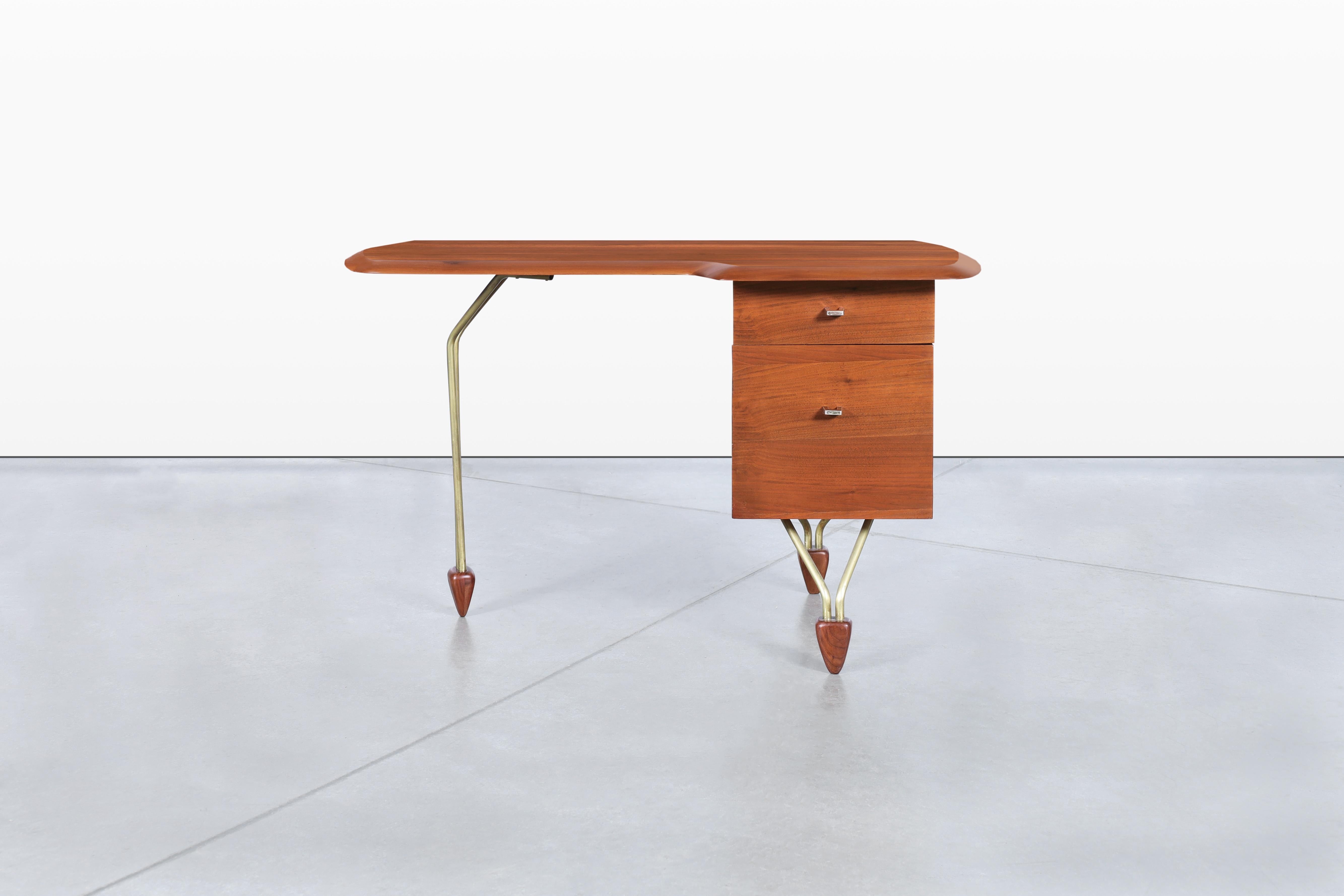 Discover a stunning vintage American craftsmanship piece—a walnut desk attributed to the renowned designer John Keal, dating back to the 1950s. This exceptional desk features an exquisite solid walnut top that showcases the natural beauty of the