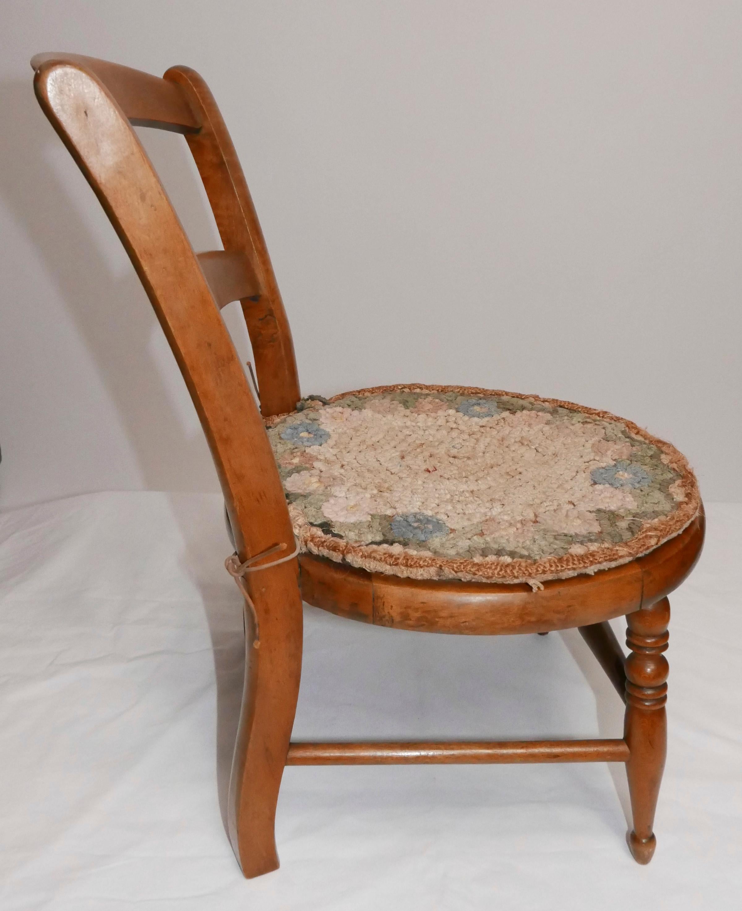 A well loved beautifully carved curly maple child's chair with handmade pad.
American, stamped: December 6 1870 - August 13 1871
In good antique condition with original patina.
 