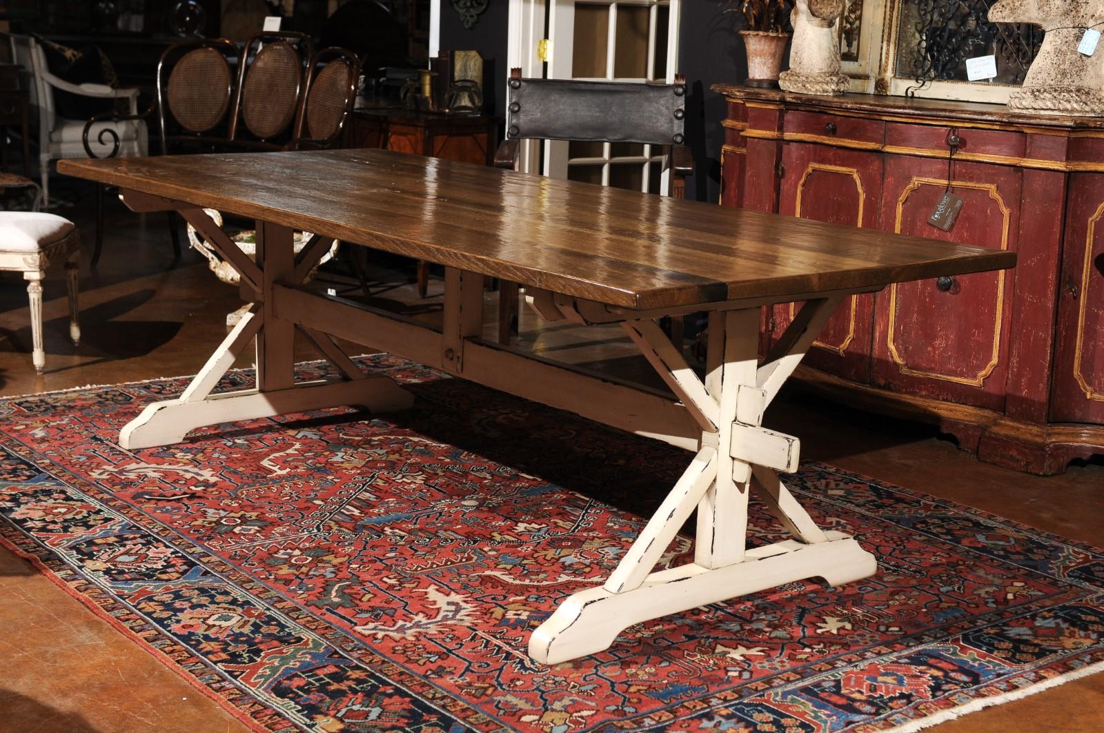 A contemporary customizable American oak dining table with whitewashed trestle base. This American trestle farm table features a rectangular quarter sawn oak top raised on a whitewashed trestle base. Bringing a strong presence to any dining room,