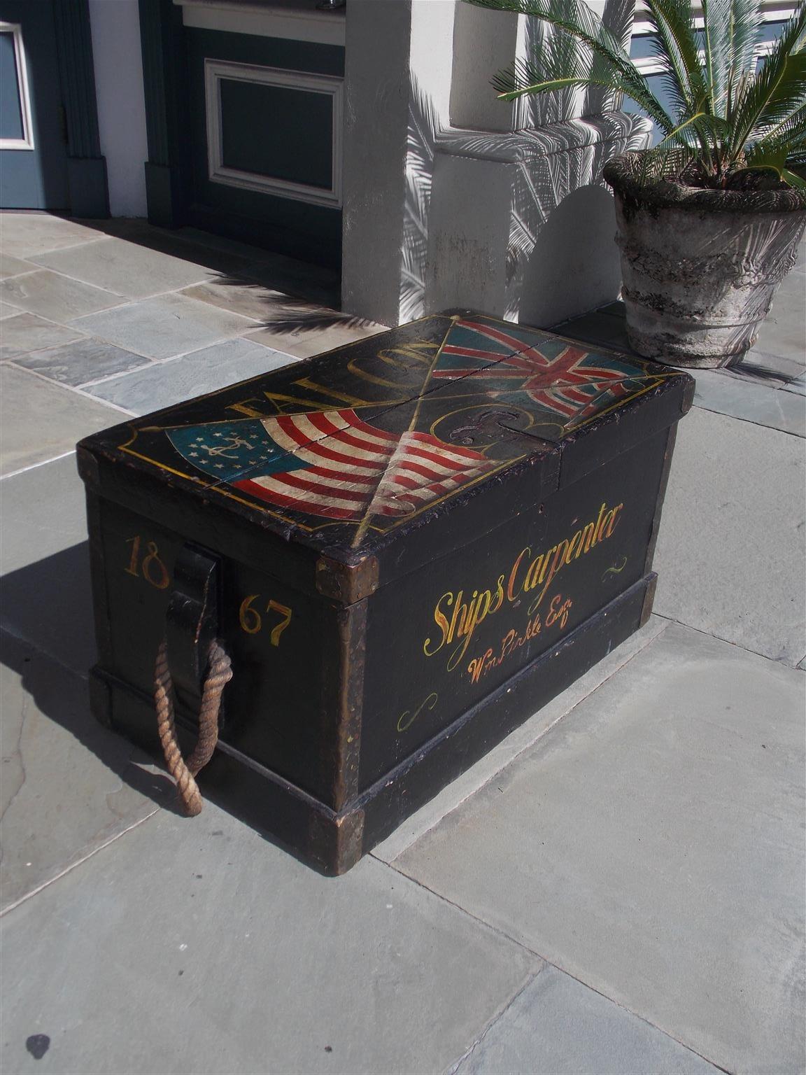 American ship's hinged carpenter trunk with exterior decorative painted American Flag and Union Jack,  interior till, original flanking rope beckets, and resting on a molded edge base. Signed and dated by maker. Mid-19th century.