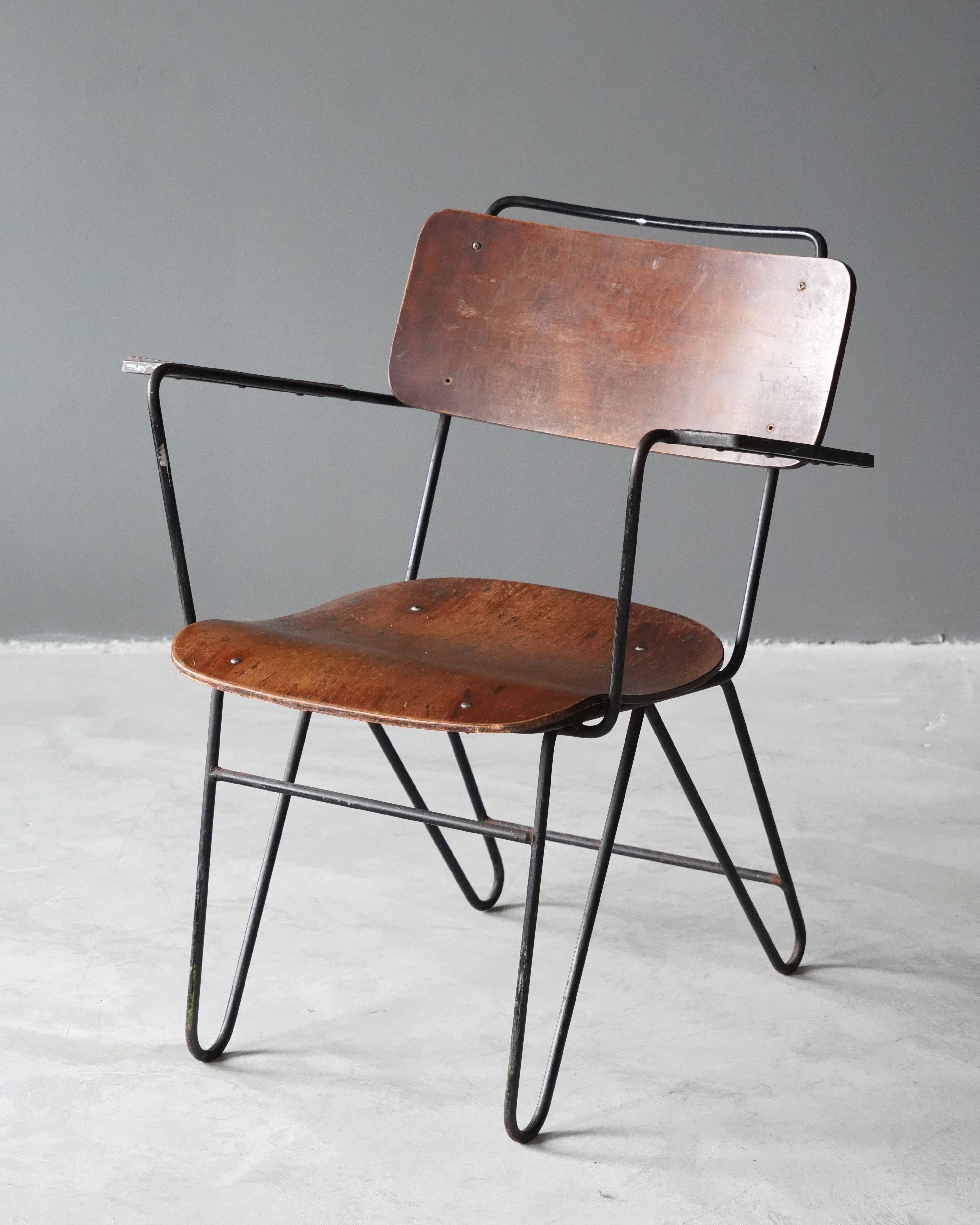A modernist armchair / side chair. Designed and produced in America, 1940s. Features moulded plywood and lacquered metal. 

Other designers of the period include Warren Mccarthur, Paul Frankl, Paul Laszlo, Charles and Ray Eames, and Kem Weber.