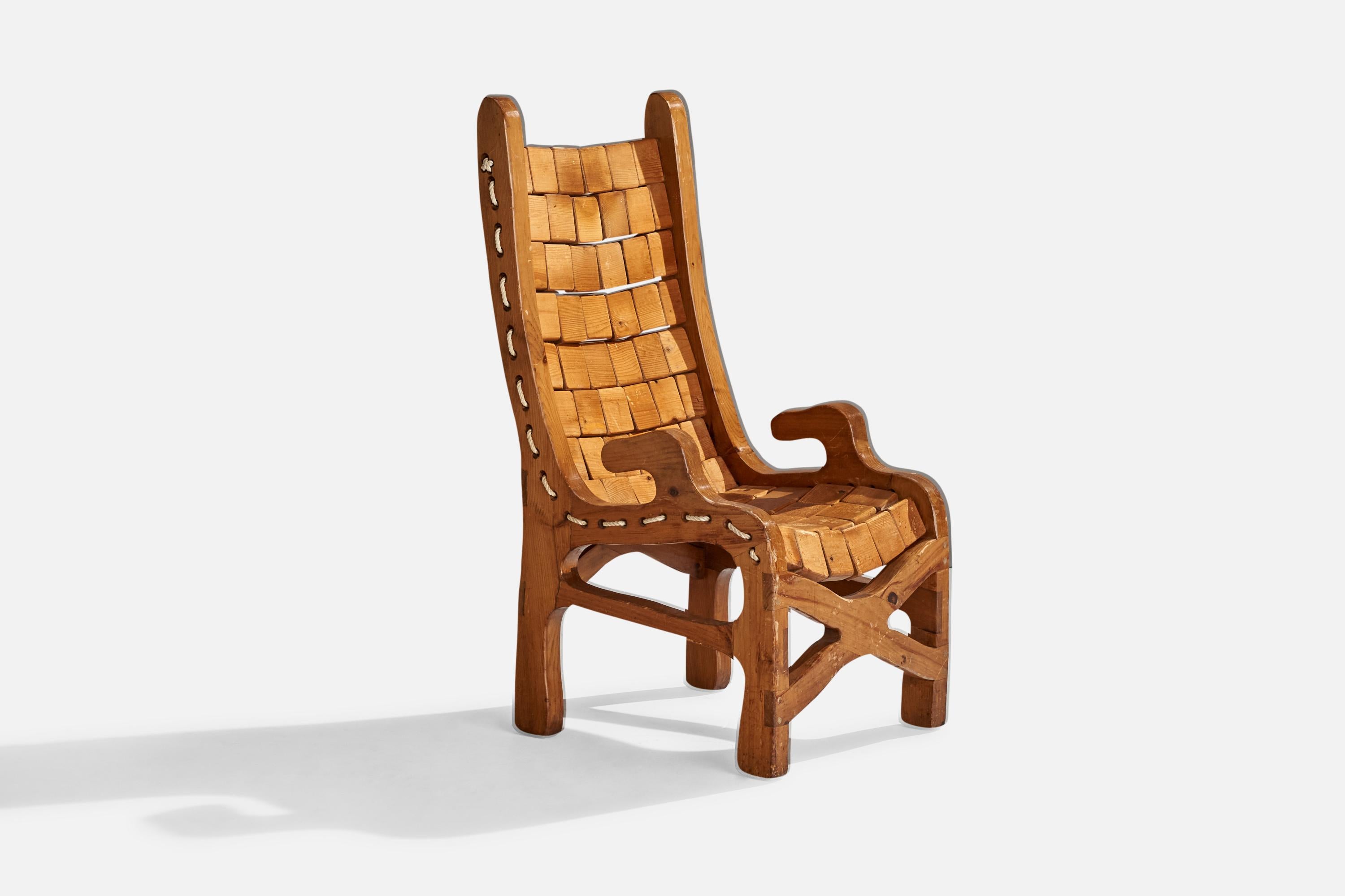A pine and cord armchair designed and produced in the US, c. 1970s.

Seat height: 17.25