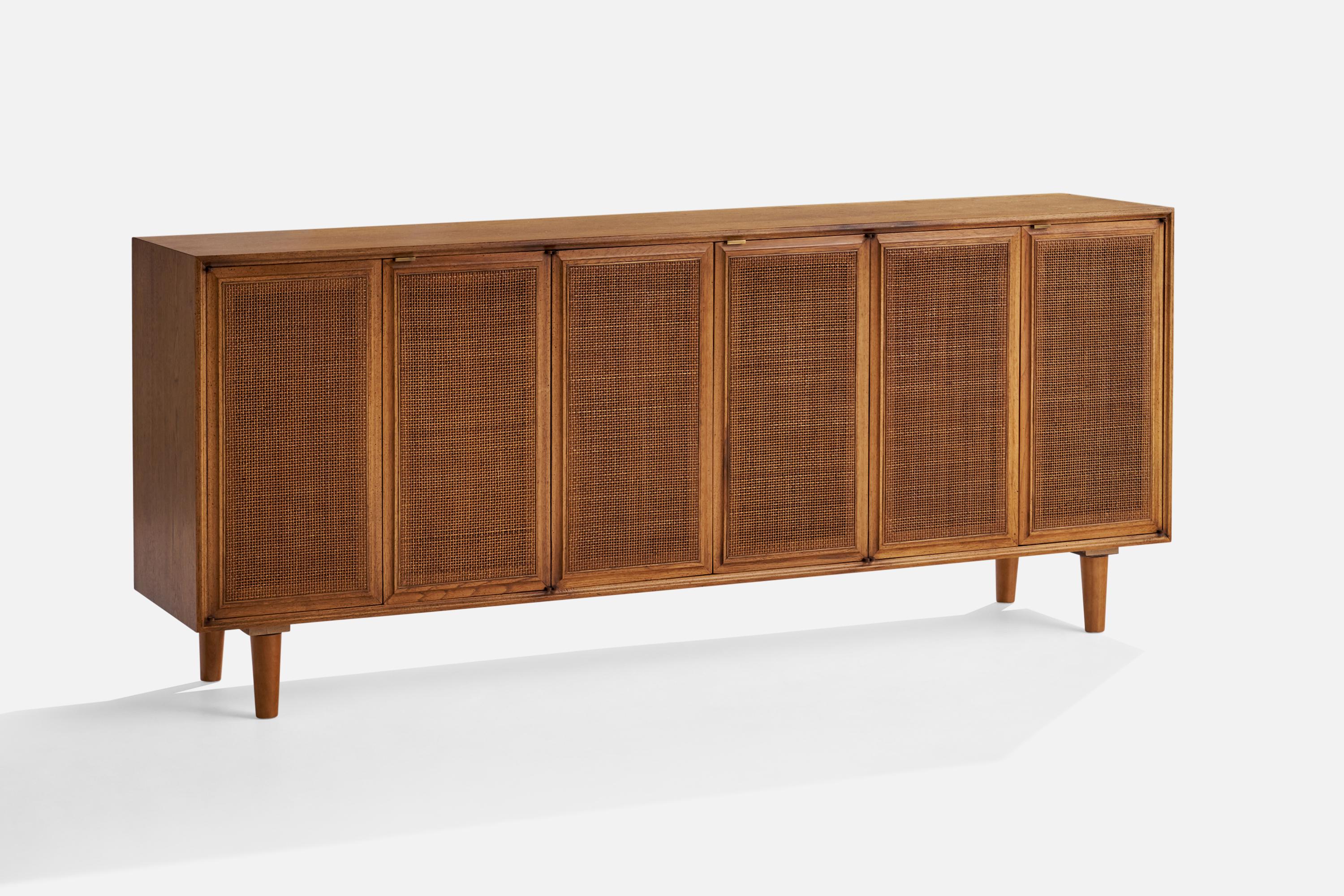 A walnut and woven rattan cabinet or credenza designed and produced in the US, 1950s.