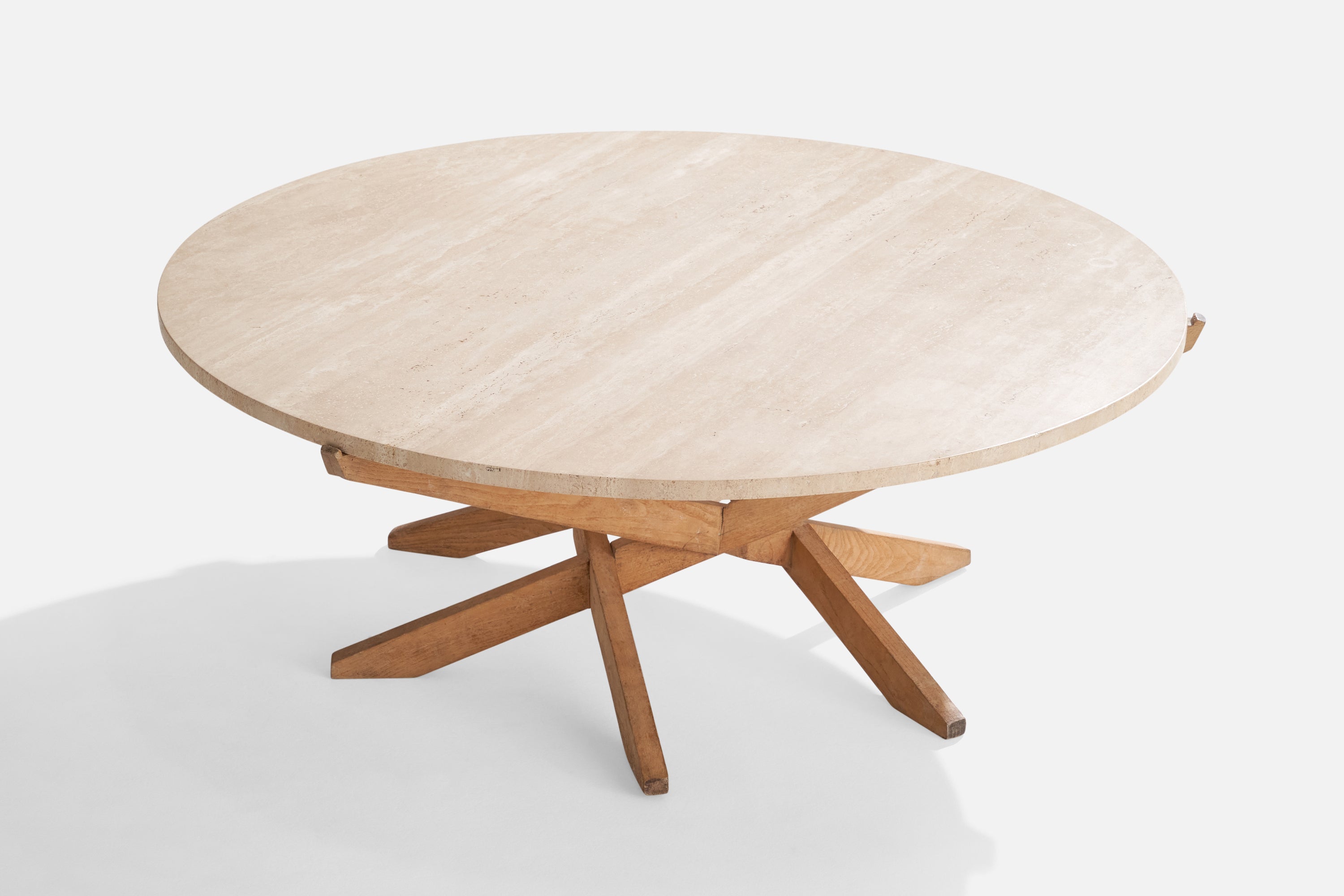 A travertine and ash coffee table designed and produced in the US, c. 1970s.

*discoloration to wood 

Dimensions: 16.5” H x 44” diameter 