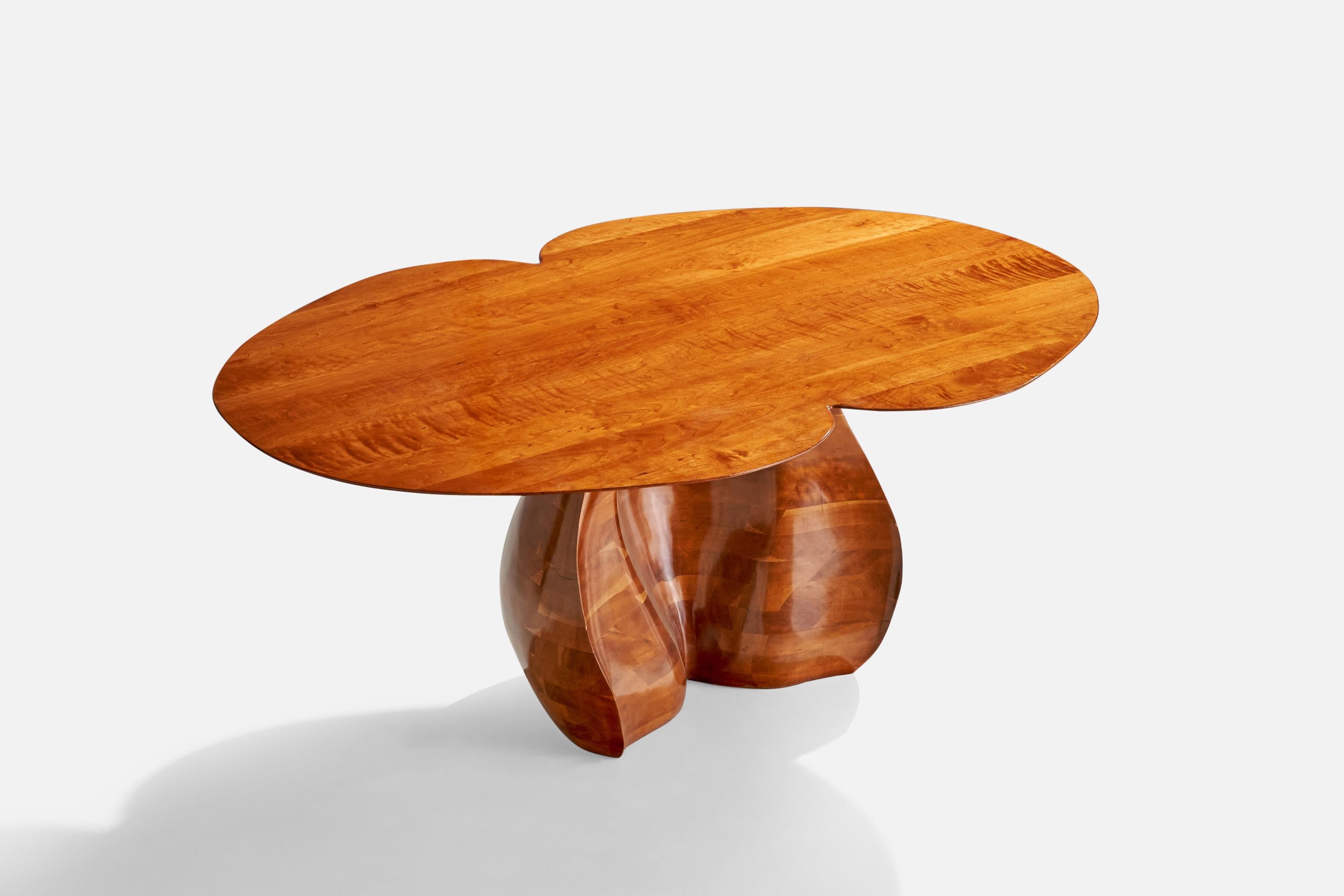 A studio-produced dining or center table designed and produced in the US, c. 1990s. 

Signed 