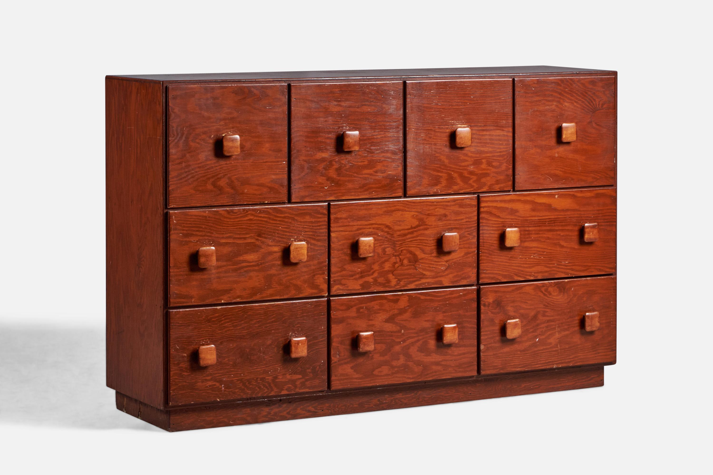 A stained oak dresser designed and produced in the US, 1940s.