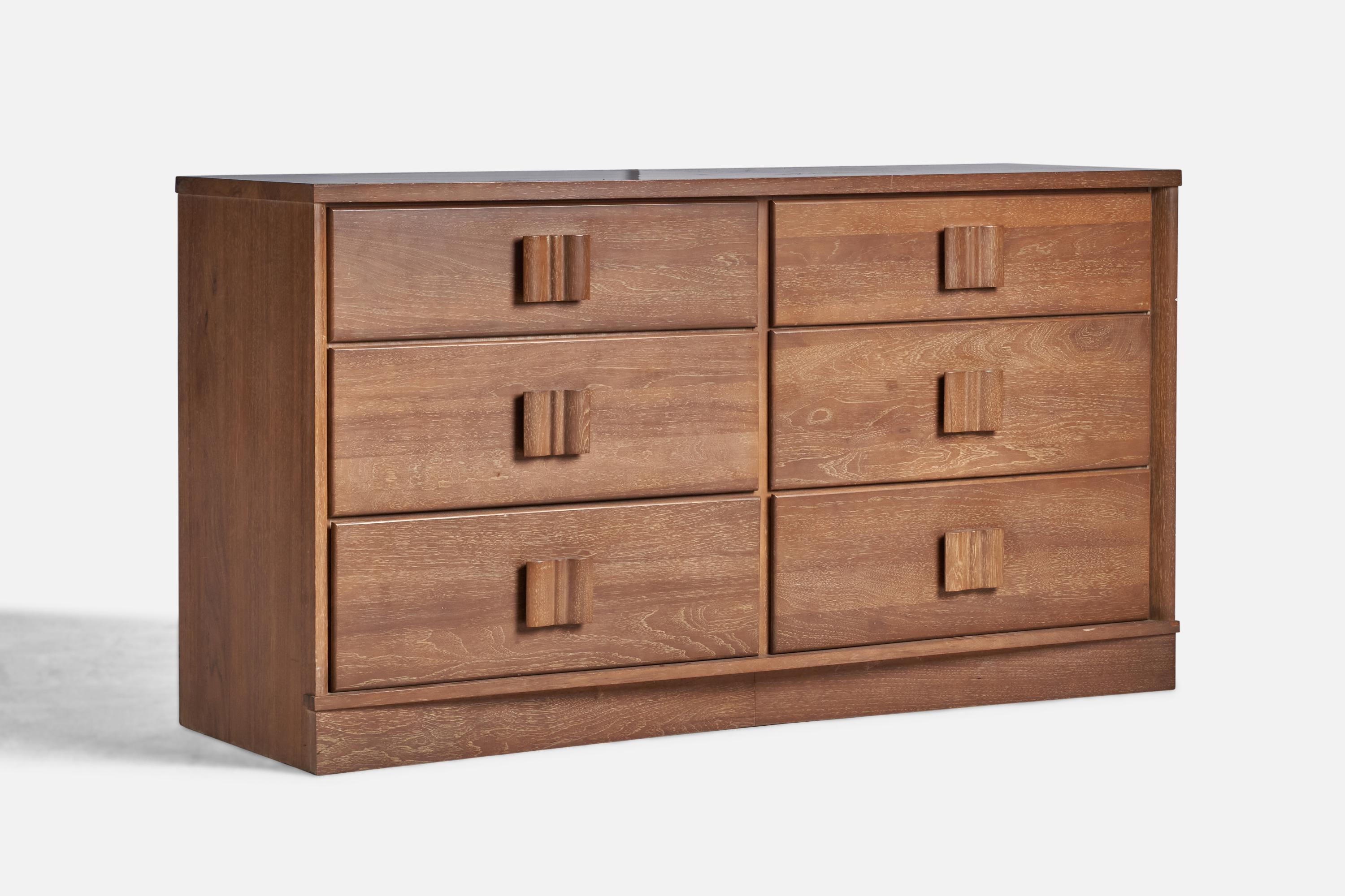 A stained oak dresser designed and produced in the US, 1940s.