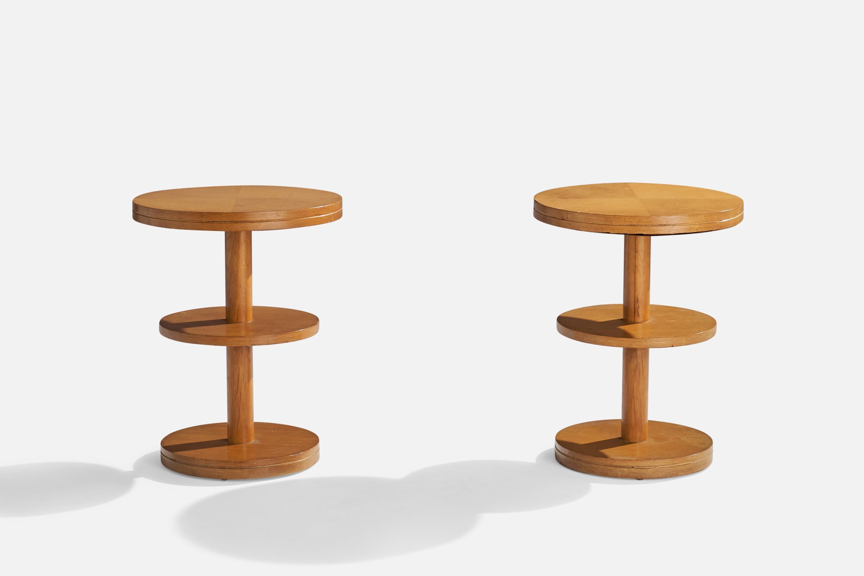 A pair of two-tiered wood end tables or side tables designed and produced in the US, 1950s.