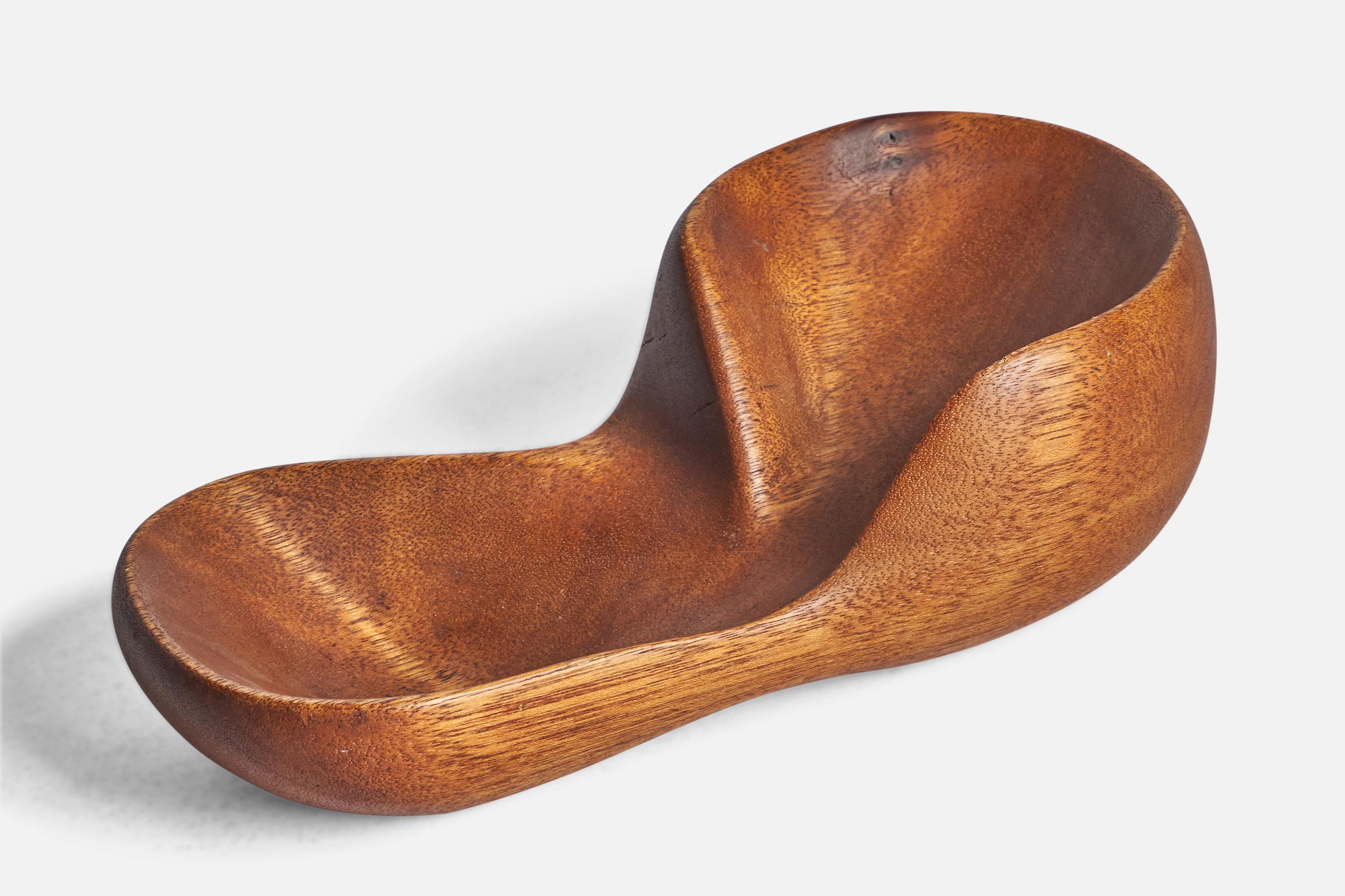 A freeform teak bowl or dish designed and produced in the US, c. 1950s.