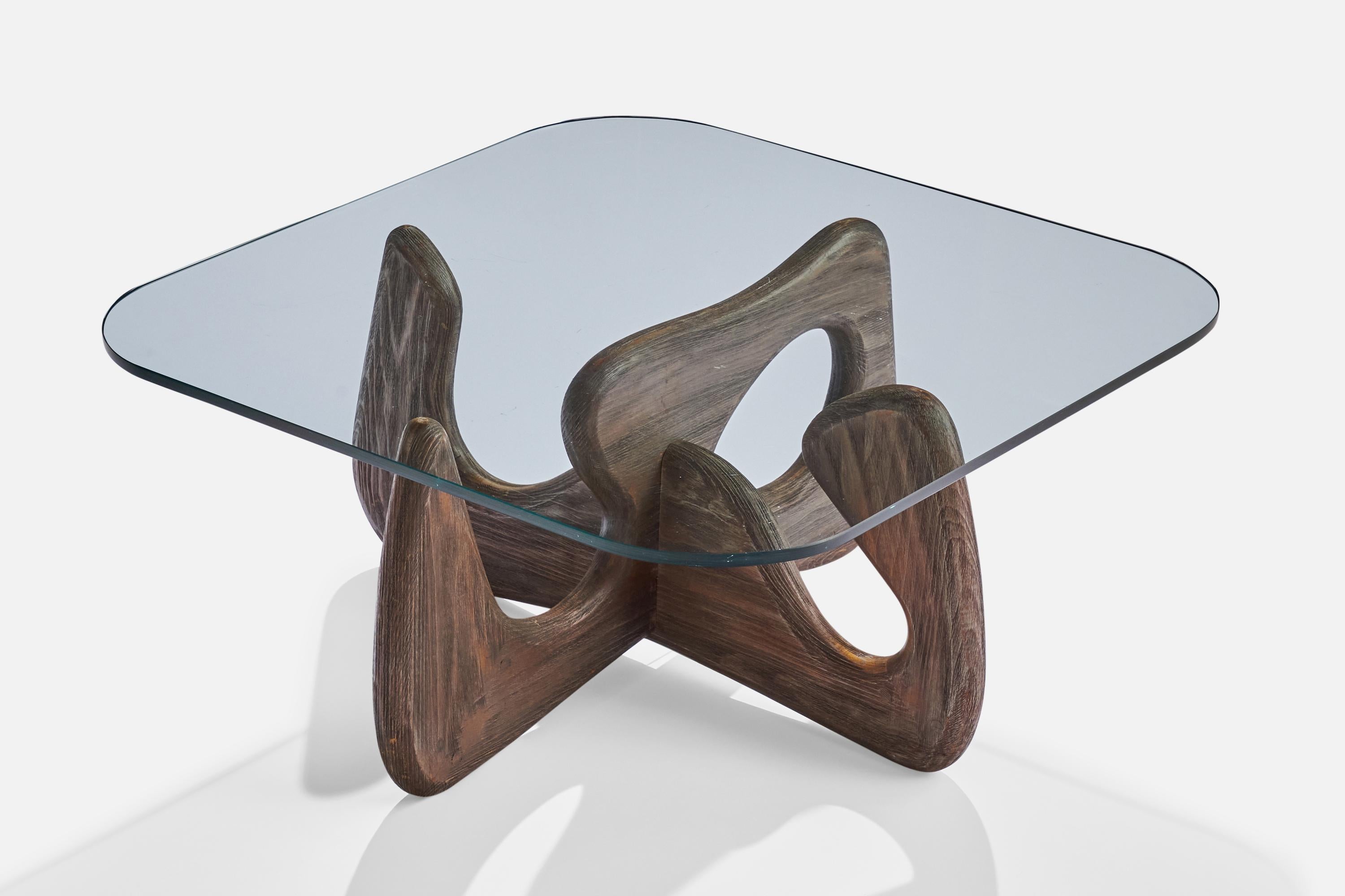 A dark-stained pine and glass coffee table designed and produced in the US, c. 1950s.