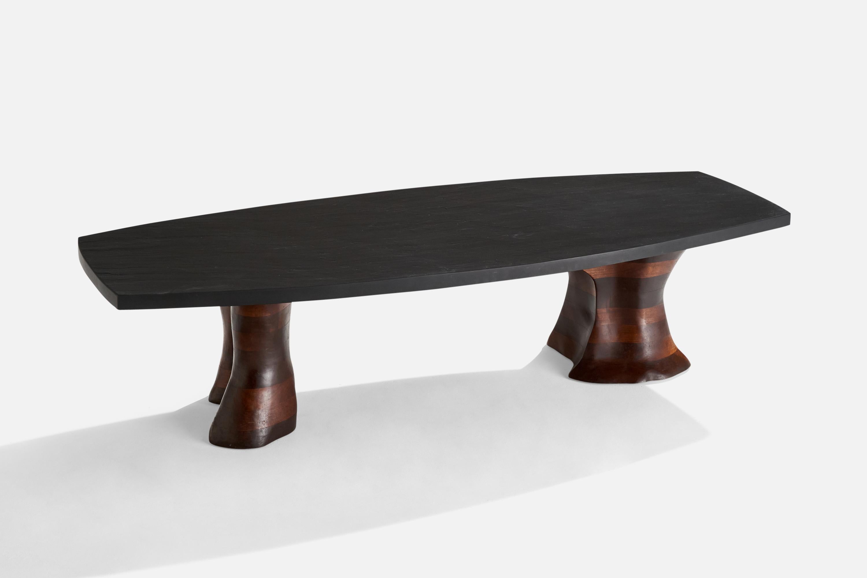 A black slate and walnut coffee table designed and produced in the US, c. 1970s.