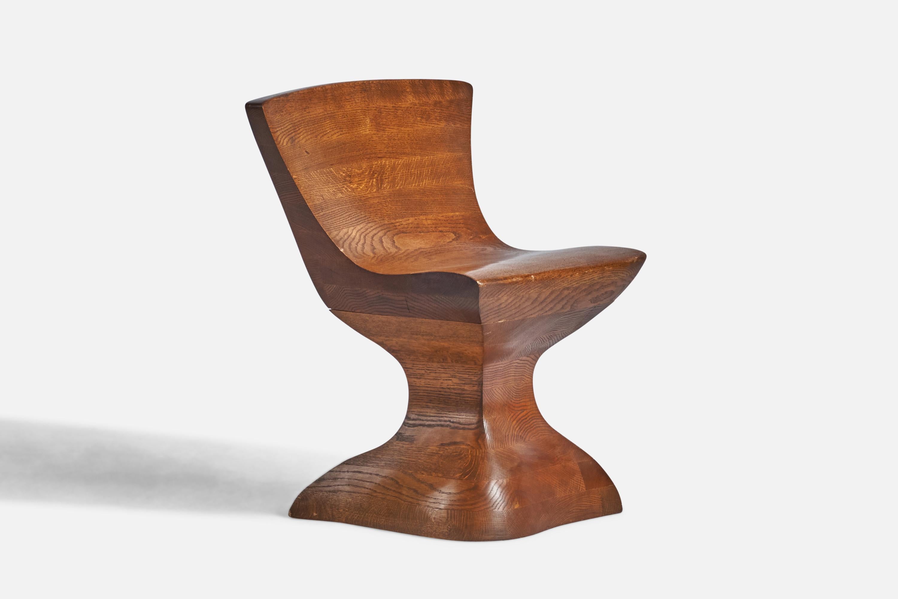 A laminated and carved oak side chair designed and produced in the US, c. 1980s.
17” seat height