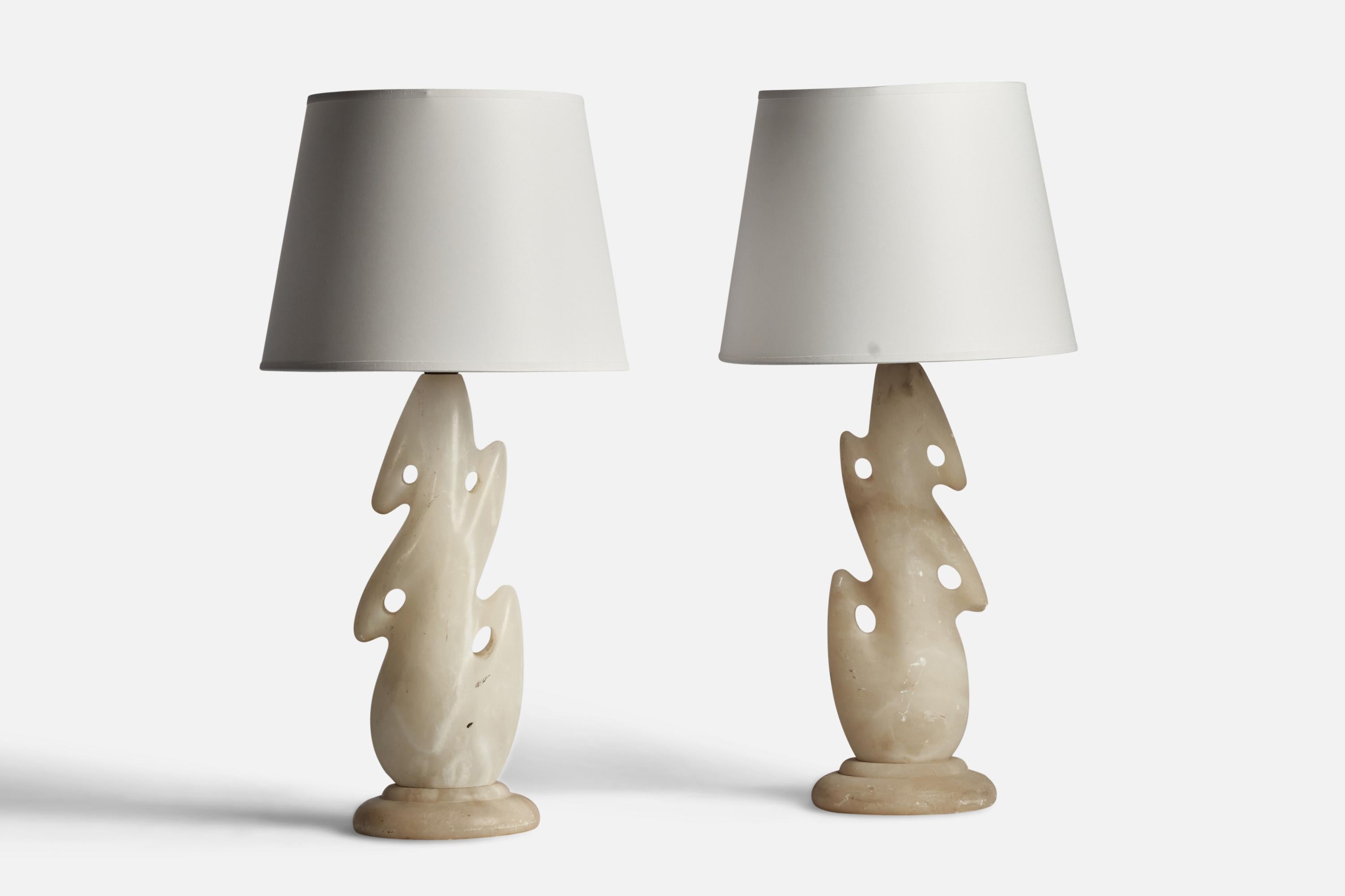 A pair of onyx table lamps designed and produced in the US, c. 1950s.

Dimensions of Lamp (inches): 18.75” H x 6.25” Diameter
Dimensions of Shade (inches): 9” Top Diameter x 12” Bottom Diameter x 9” H 
Dimensions of Lamp with Shade (inches): 24” H x