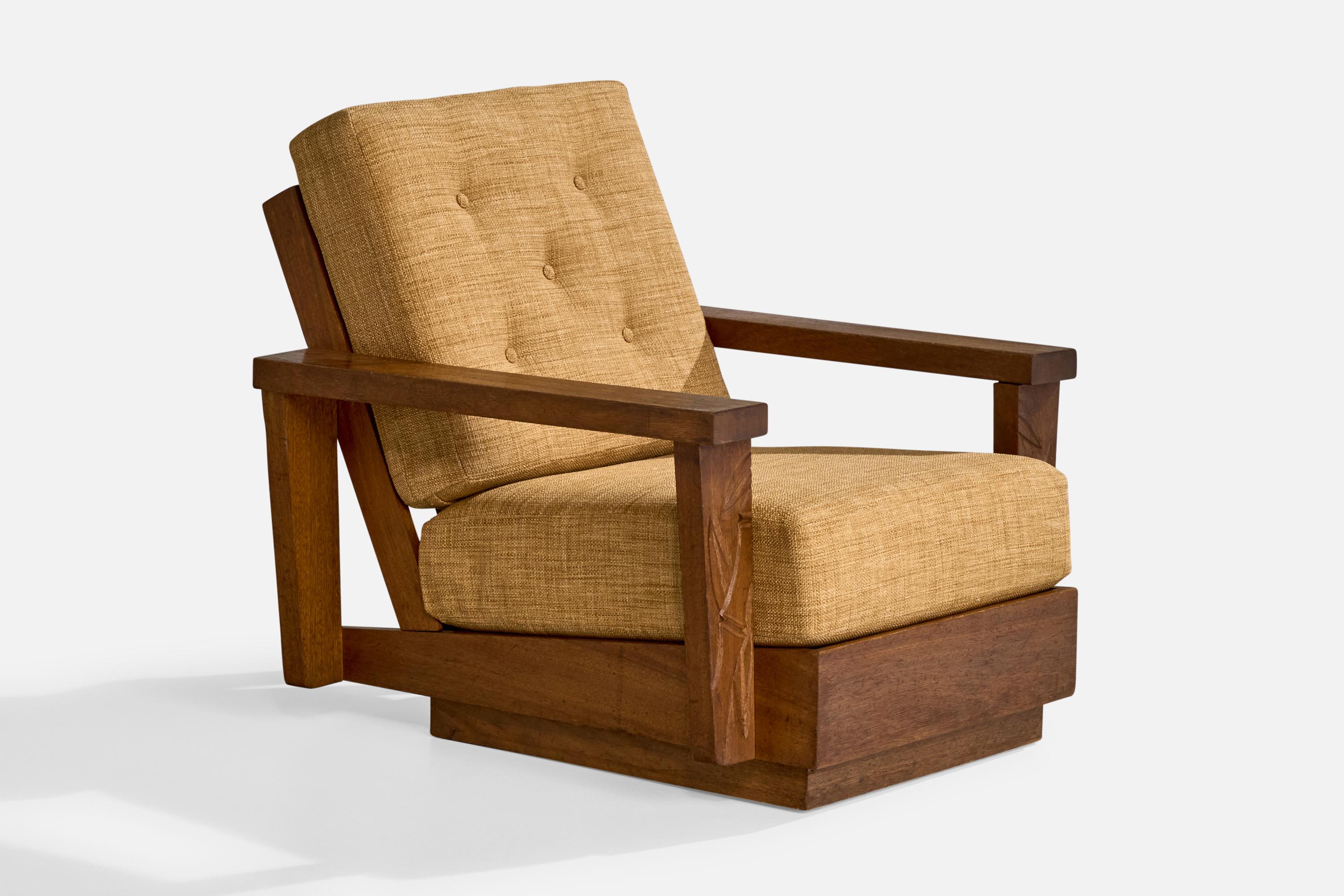 A dark-stained and carved oak and yellow fabric lounge chair designed and produced in the US, c. 1950s.

Reupholstered in brand new fabric.

Dimensions: 33” H x 31.375” W x 36.4” D

Seat Height: 15.75” 