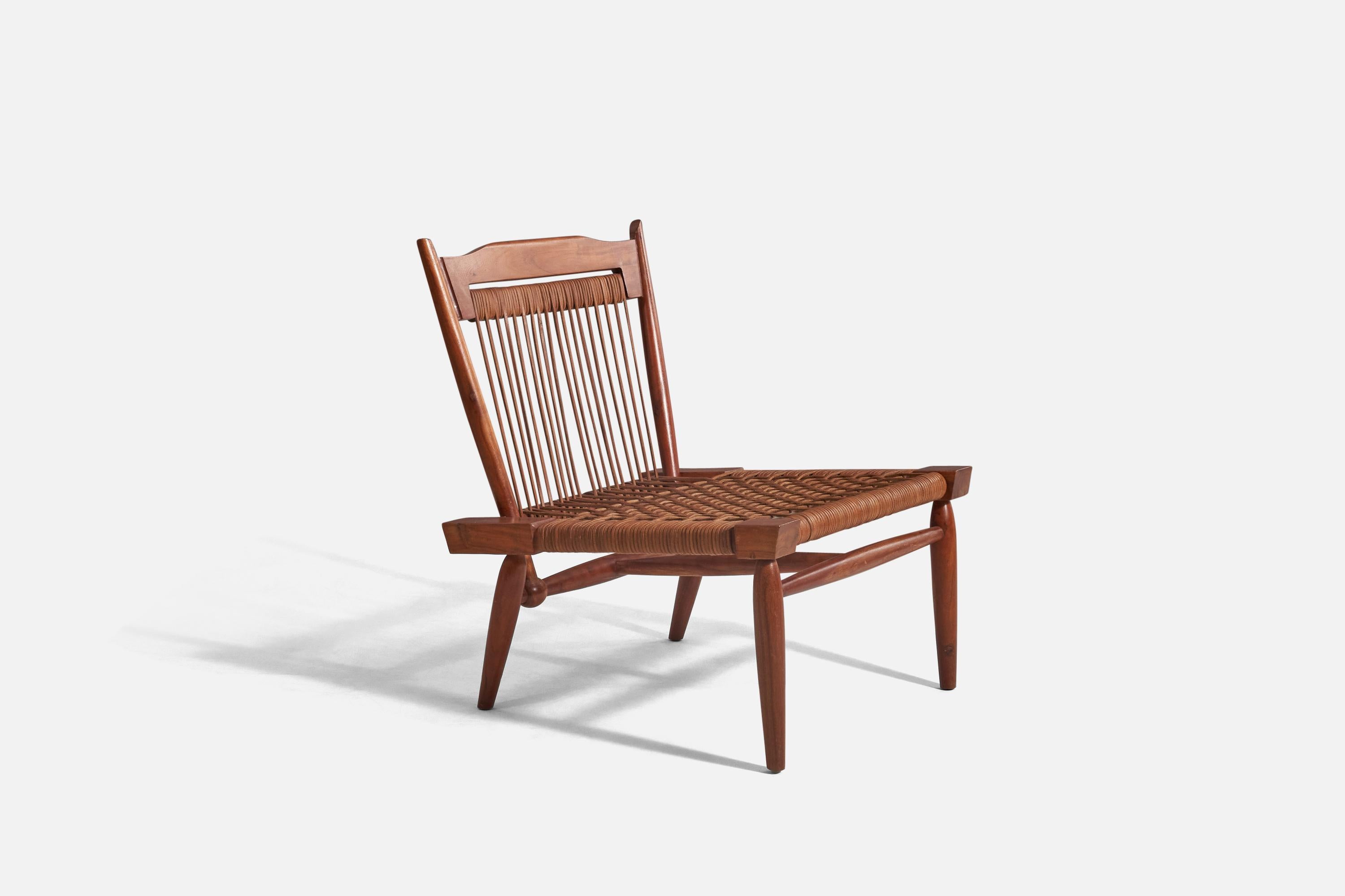 A walnut and cane lounge chair designed and produced by an American designer, United States, 1960s.






