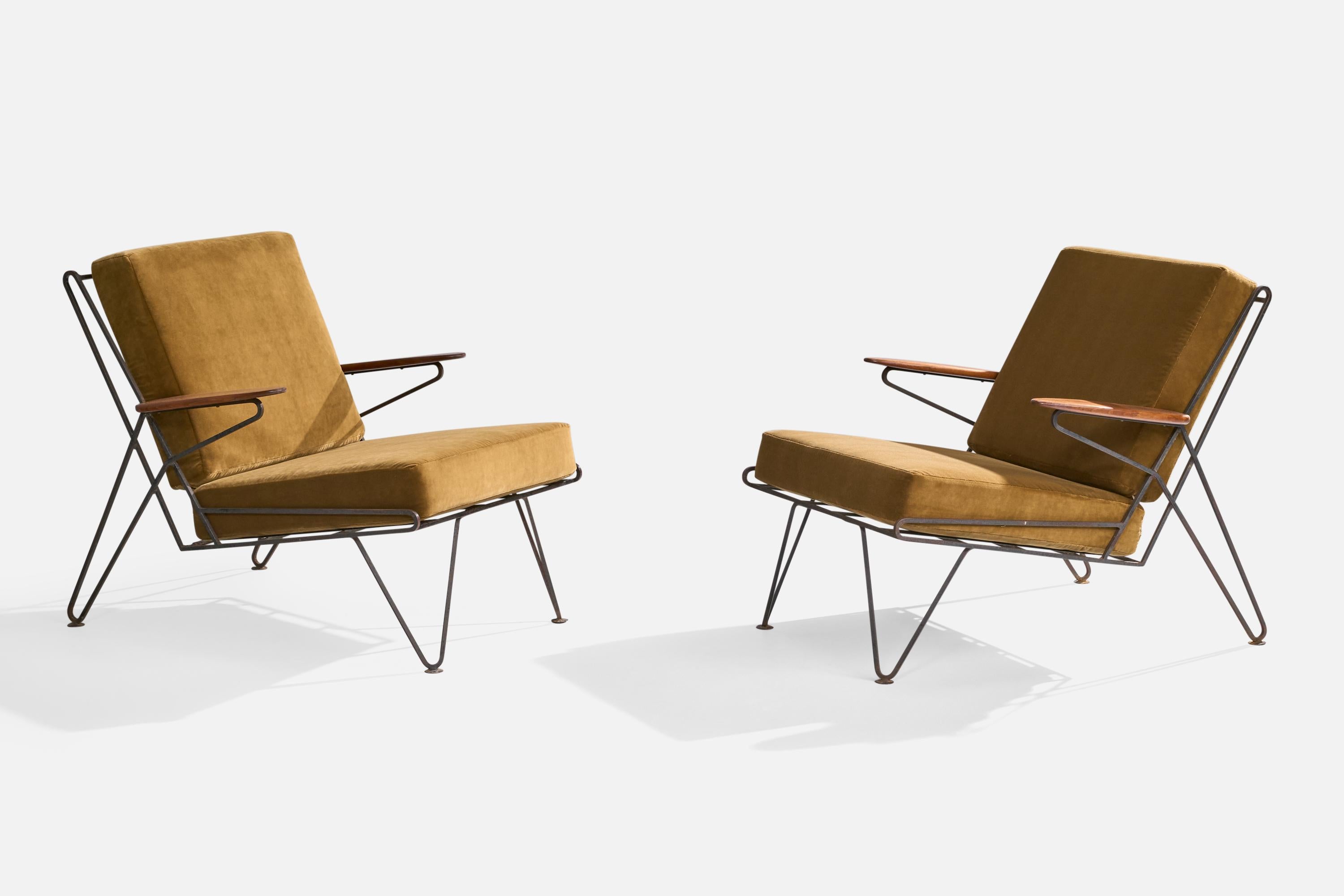 A pair of iron, wood and beige velvet lounge chairs designed and produced in the US, c. 1950s.

The metal frame presents with very heavy oxidation throughout. Reupholstered in brand new velvet.

Dimensions: 32” H x 29.25” W x 35” D

Seat Height: