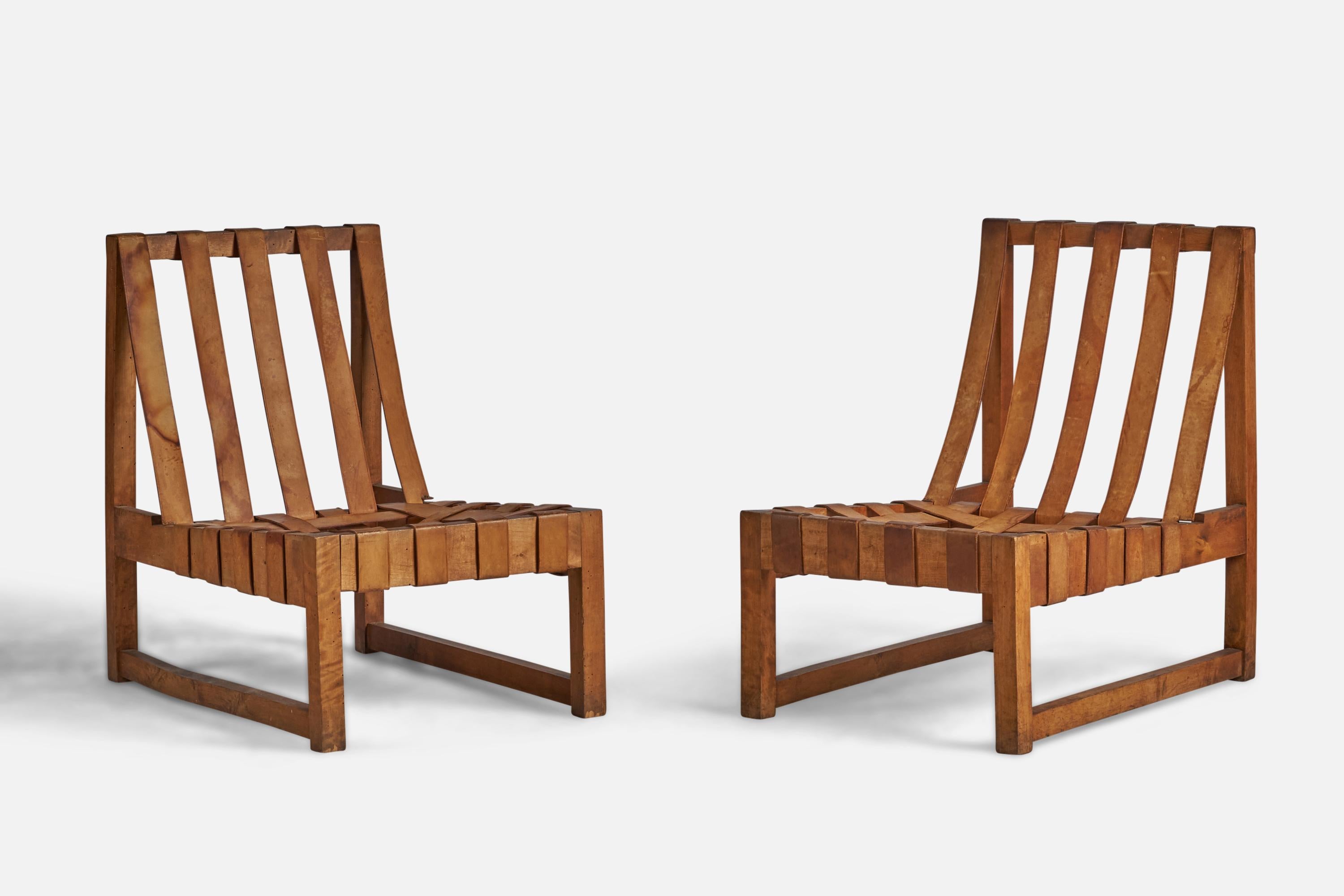 A pair of oak and leather lounge or slipper chairs designed and produced in the US, c. 1950s.

11.75” seat height