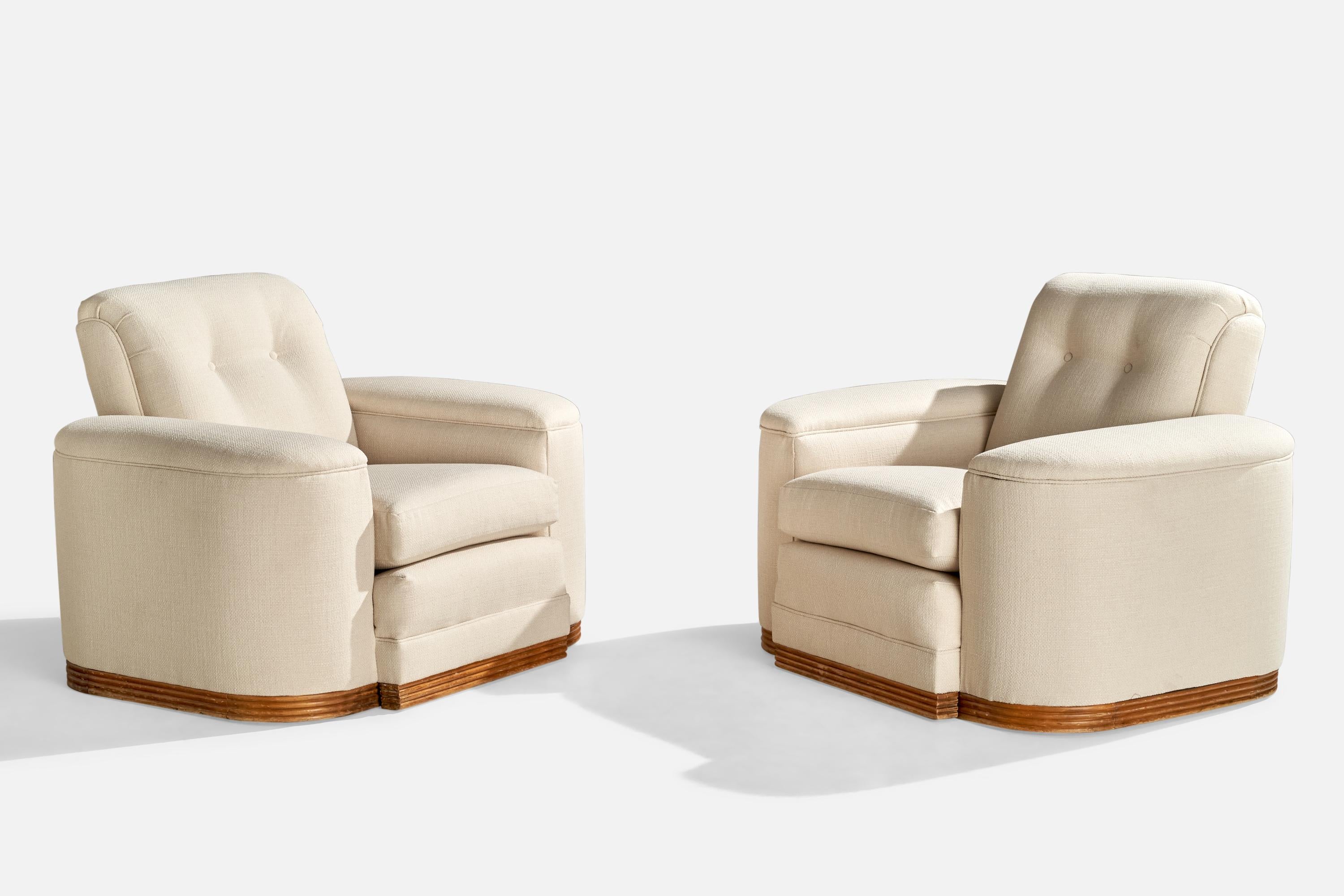 A pair of wood and white fabric lounge chairs designed and produced in the US, c. 1950s.

Seat Height: 18