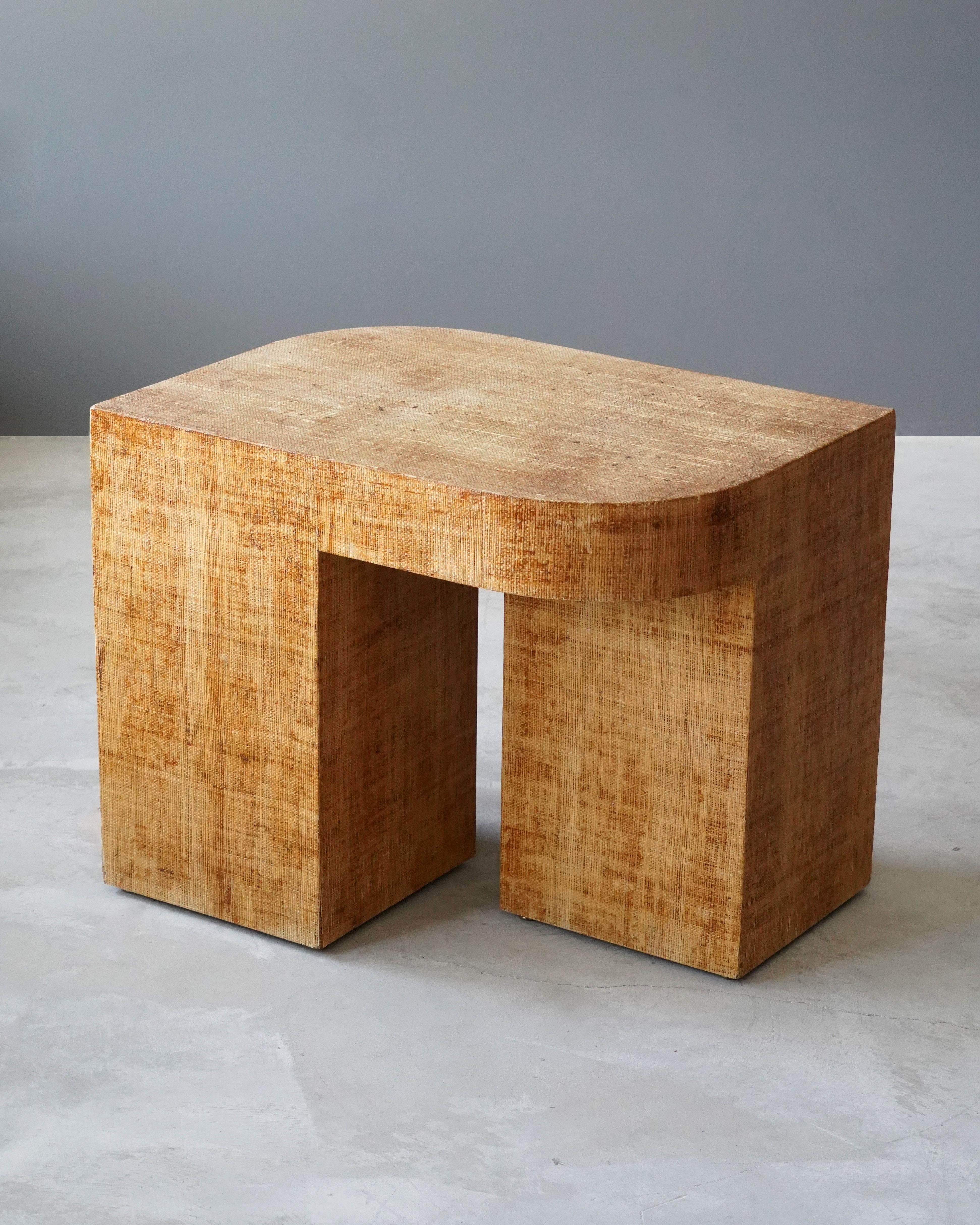 A minimalist side table or end table. Designed and produced in the United States, 1970s. Features grasscloth / raffia over wood.

Other designers of the period include Karl Springer, Vladimir Kagan, Vladimir Kagan, Paul Frankl, and Donald Judd.