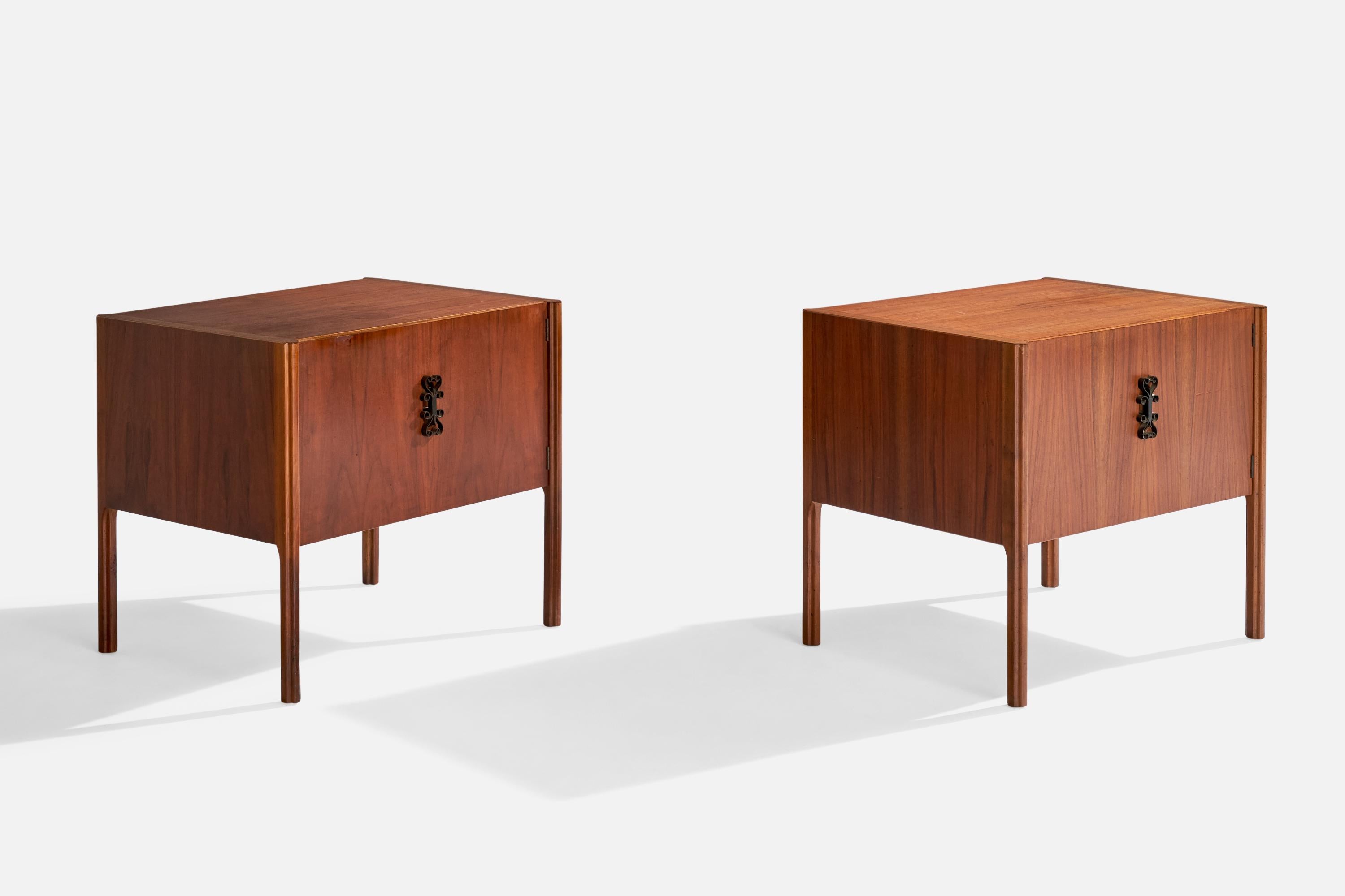 A pair of walnut and black-lacquered iron nightstands designed and produced in the US, c. 1950s.

23.125” H x 25.875” W x 20” D