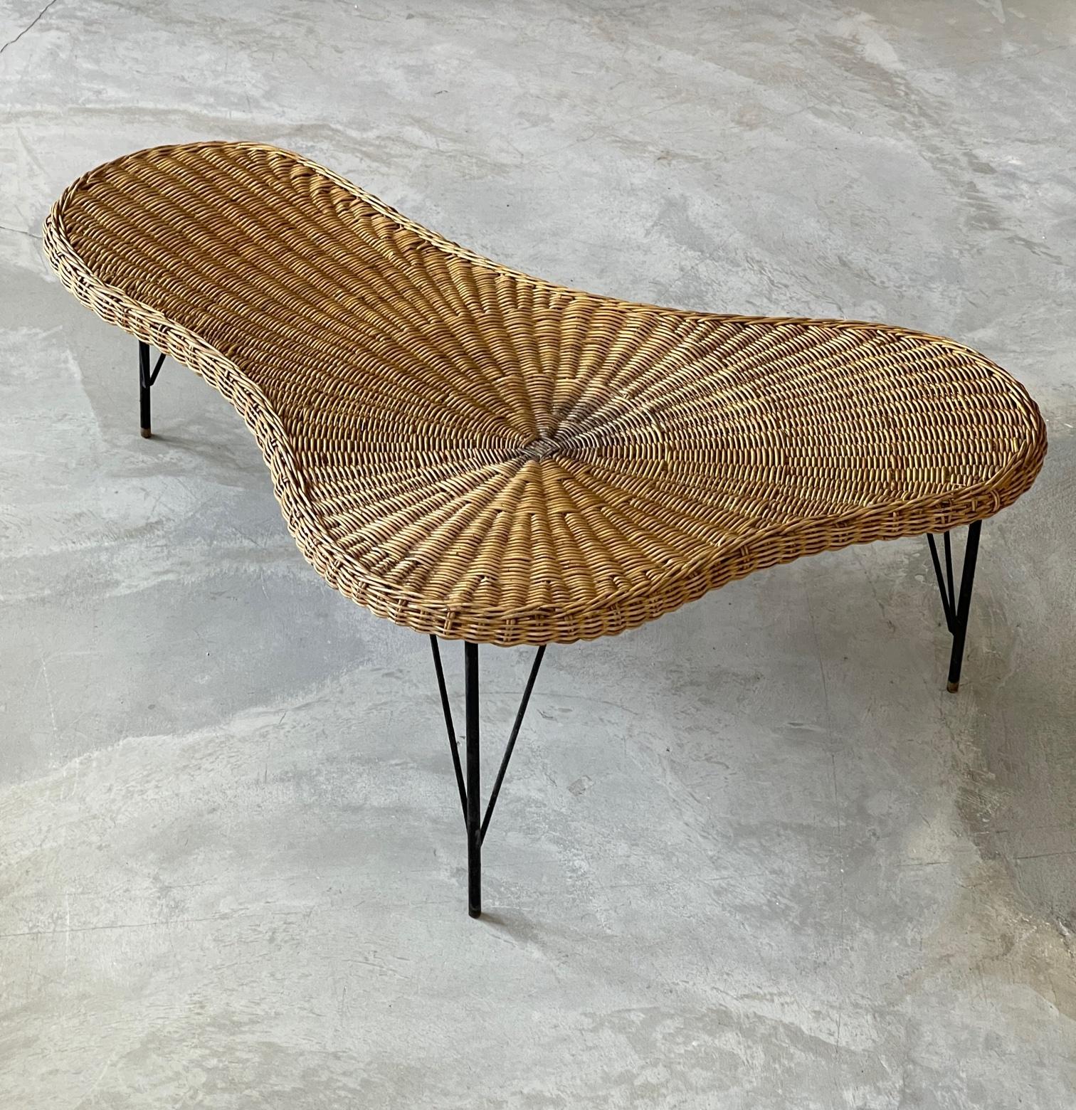 An organic / biomorphic / free form coffee / cocktail table. In woven rattan, original black-lacquered metal legs, with brass caps.

Other designers of the period include Paul Frankl, T.H. Robsjohn-Gibbings, Jean Royere, Vladimir Kagan, and George