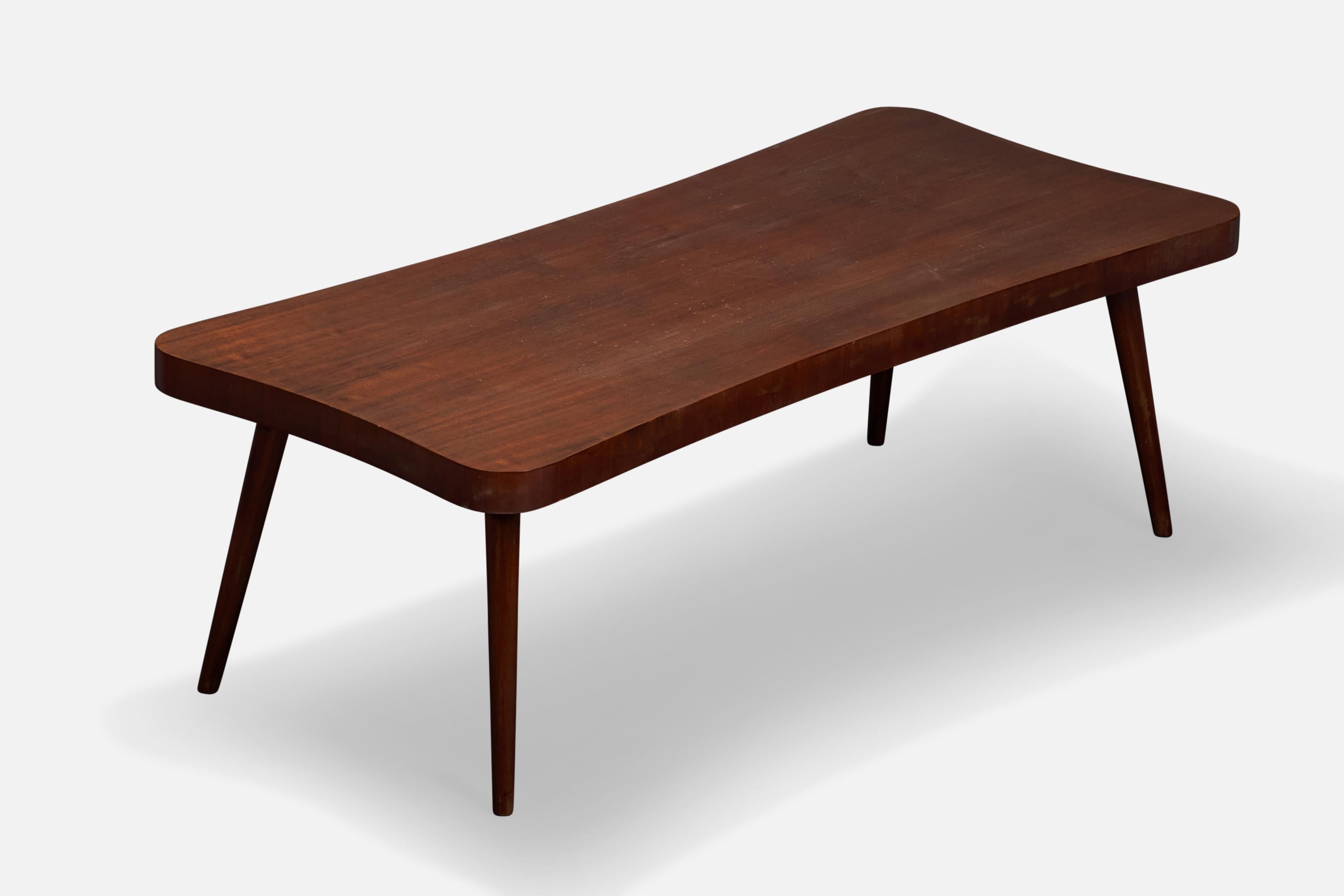 An organic walnut coffee table designed and produced in the US, 1940s.