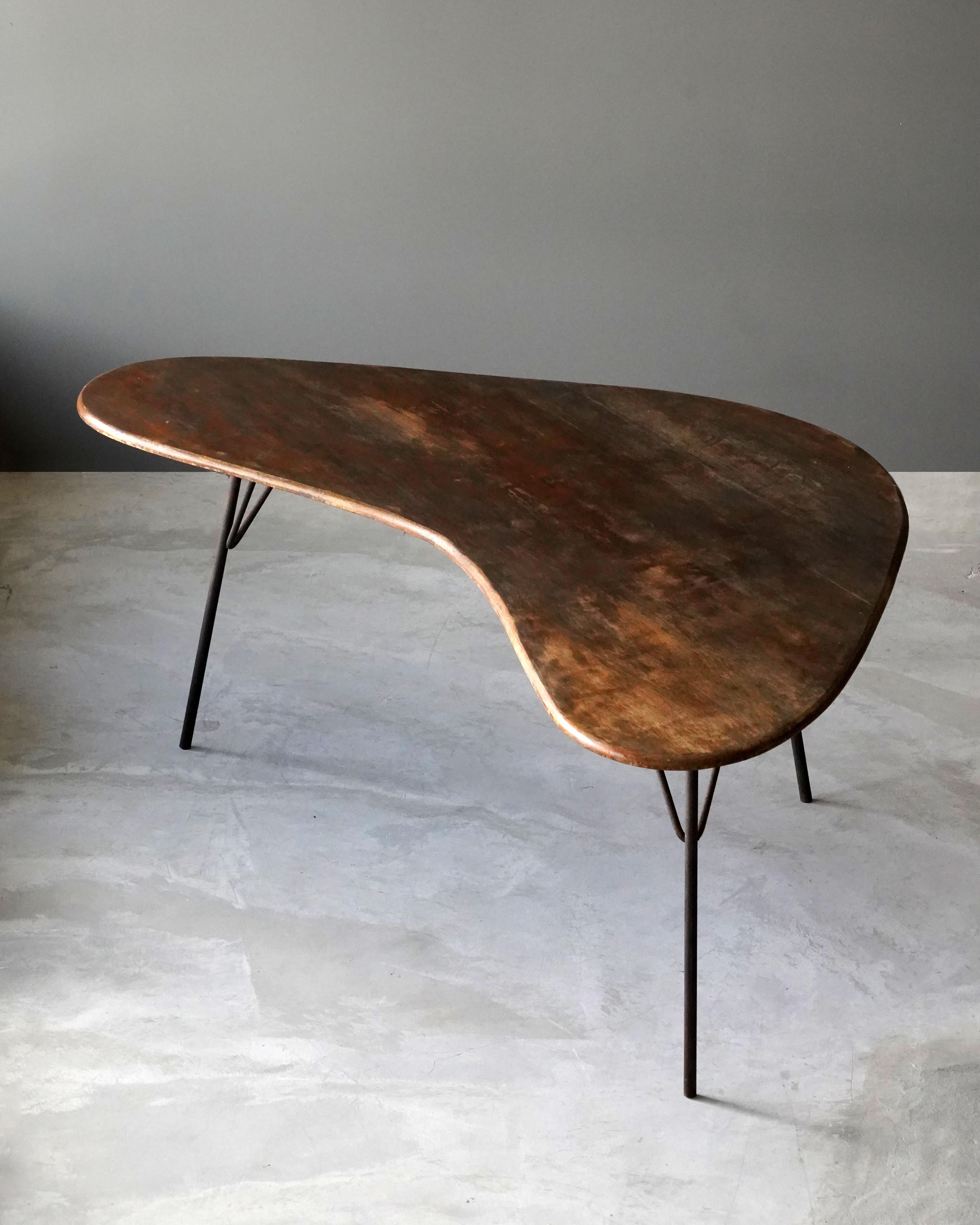 An organic or freeform table or writing table or desk. By an unknown designer, 1950s, America. 

Other designers of the period include George Nakashima, Isamu Noguchi, Charlotte Perriand, Vladimir Kagan, and Paul Frankl.