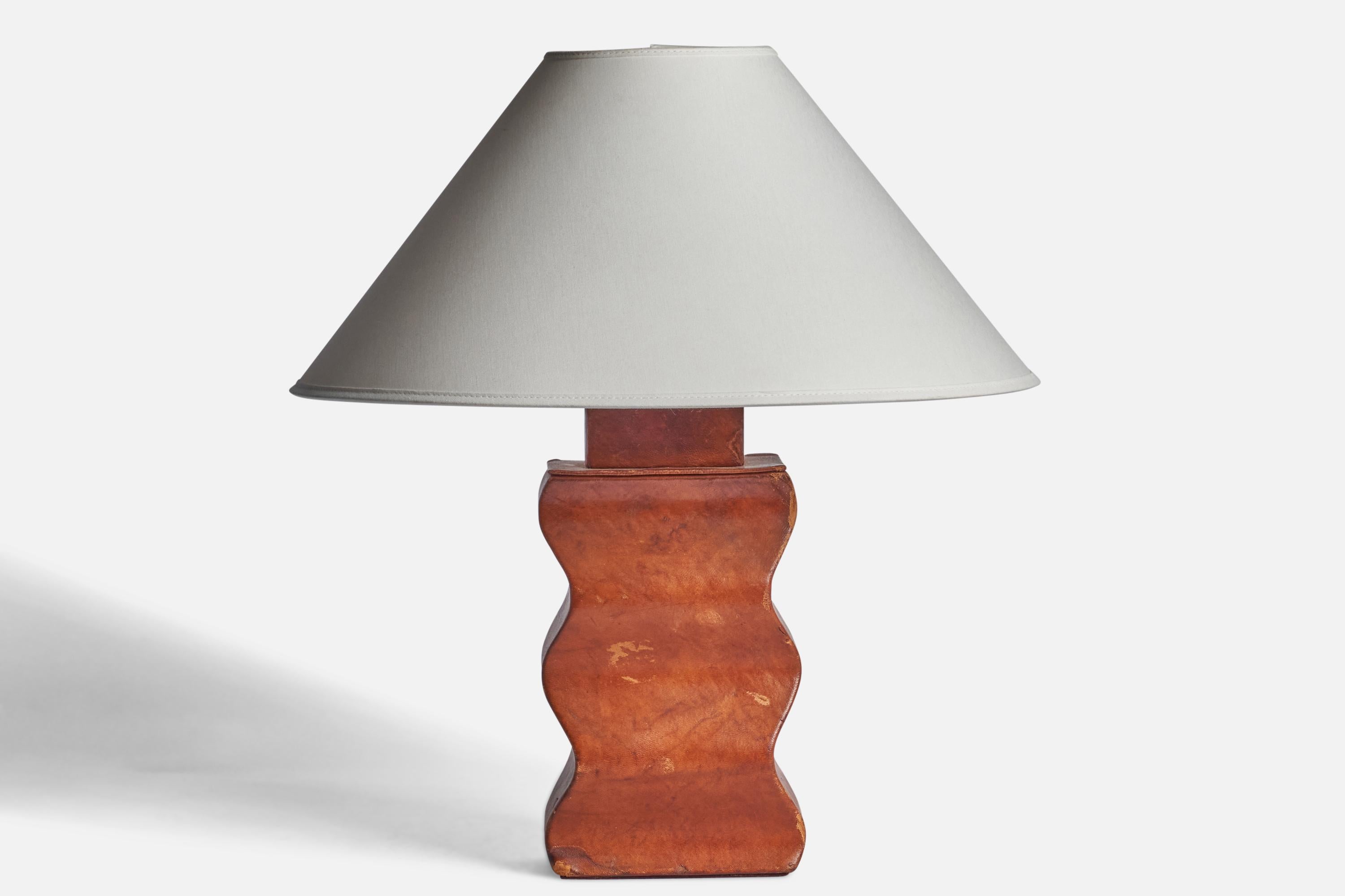 
An organic leather-clad wood table lamp designed and produced in the US, 1940s.
Dimensions of Lamp (inches): 13.15” H x 5.5” W x  4” D
Dimensions of Shade (inches): 4.5” Top Diameter x 16” Bottom Diameter x 7.25” H
Dimensions of Lamp with Shade