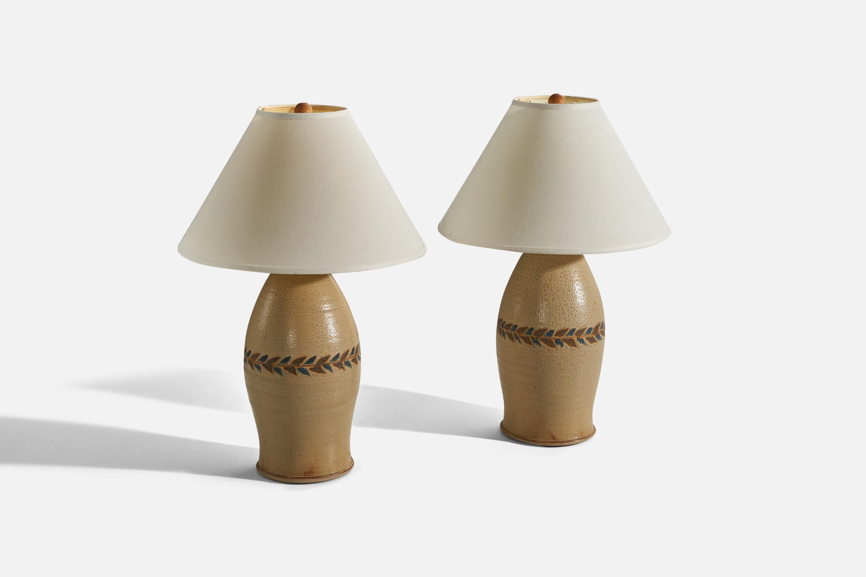 A pair of ceramic table lamps designed and produced in the United States, 1970s.

Sold without lampshade. 
Dimensions of Lamp (inches) : 18.62 x 8.62 x 8.62 (H x W x D)
Dimensions of Shade (inches) : 6 x 17.25 x 11 (T x B x S)
Dimension of Lamp