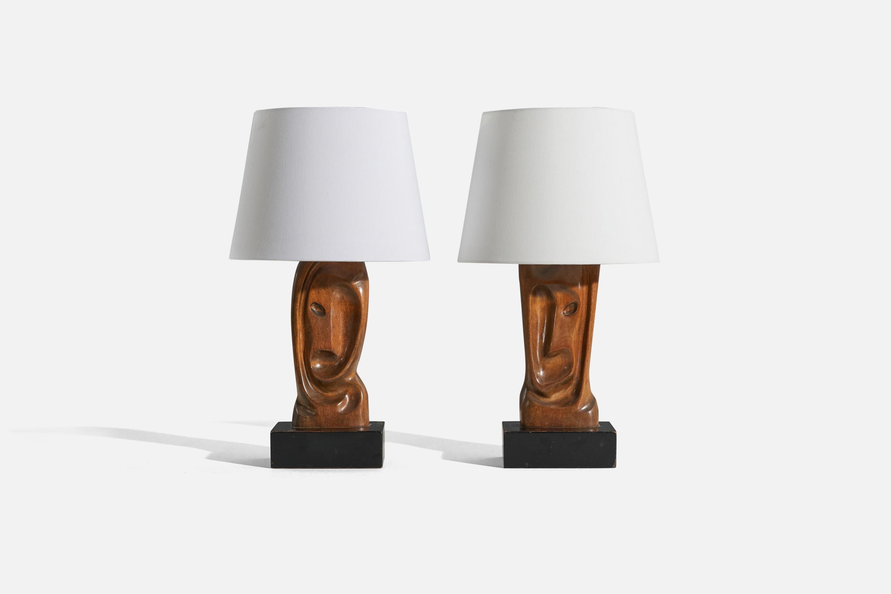 A pair of oak table lamps designed and produced in the United States, 1950s.

Sold without lampshade. 
Dimensions of Lamp (inches) : 17 x 6.625 x 6.625 (H x W x D)
Dimensions of Shade (inches) : 15.9375 x 12 x 9 (T x B x S)
Dimension of Lamp